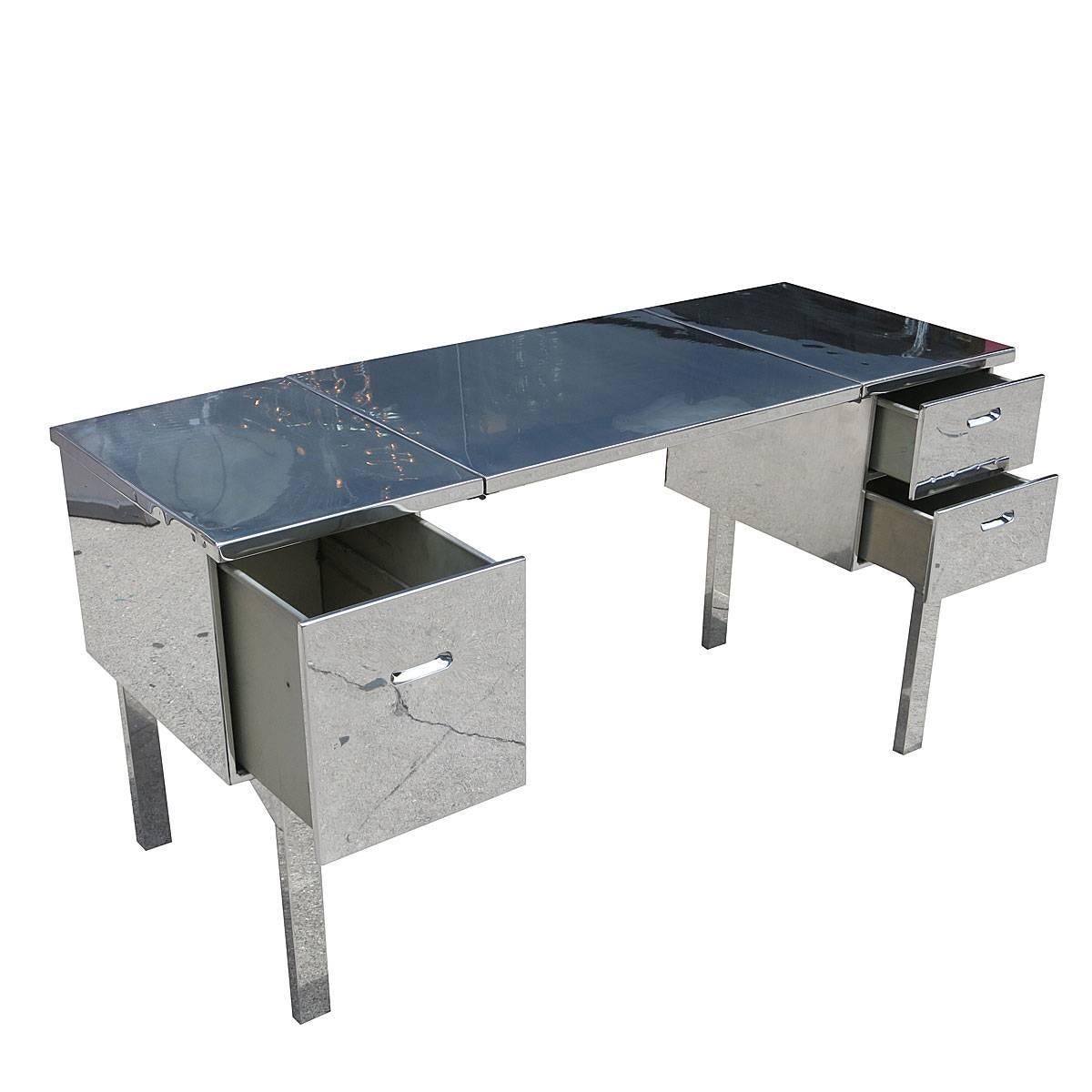 Originally designed for officers on the field in World War II this aluminum campaign desk has been refinished with a mirrored polish. It comes with three side drawers and easily folds up into the size of a large suitcase. Great for Desk, Vanity 

A