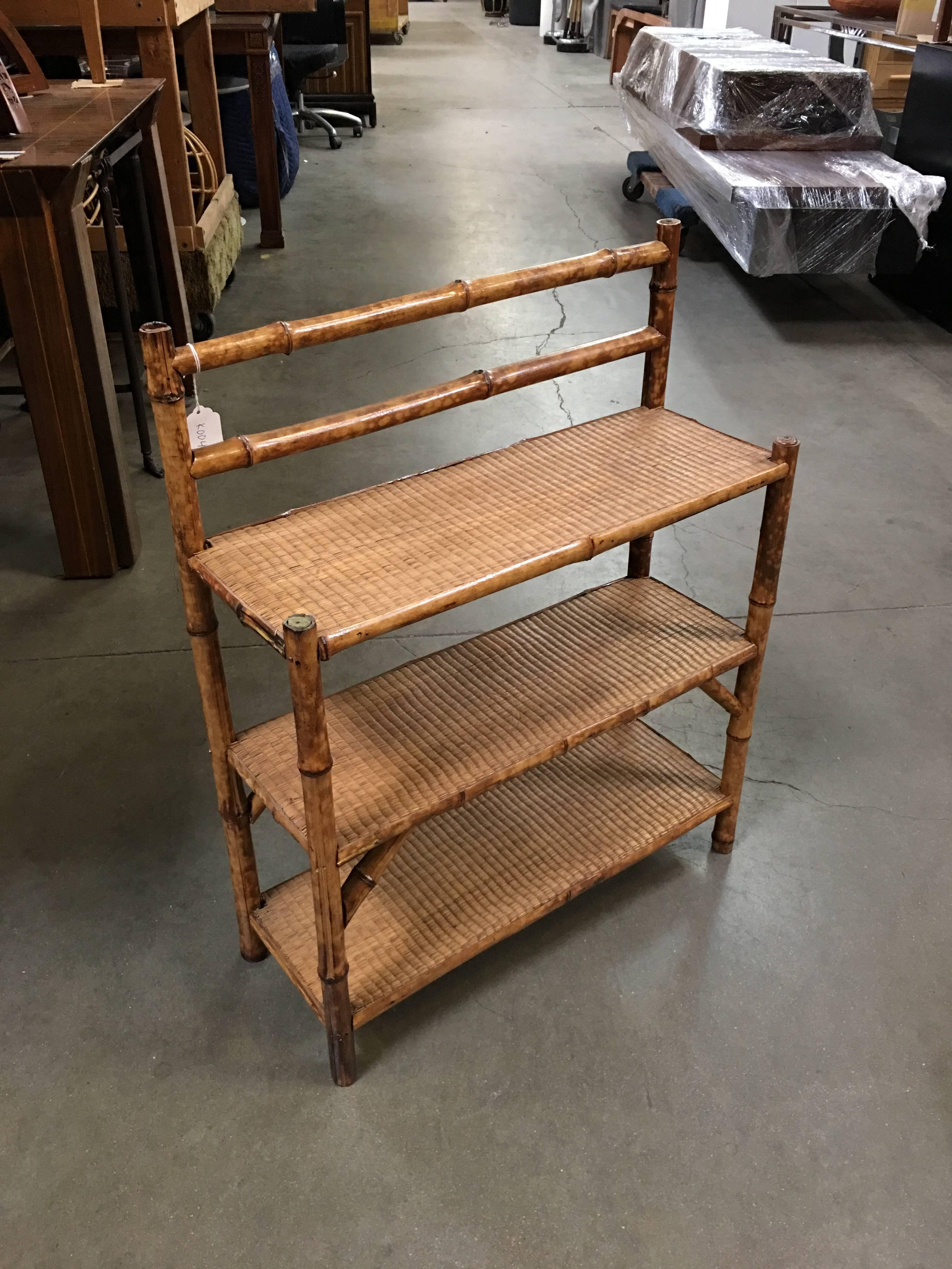 Antique three-tier tiger bamboo shelf which also works as a table top rack with rice mat top.

Refinished to new for you.

All rattan, bamboo and wicker furniture has been painstakingly refurbished to the highest standards with the best materials.