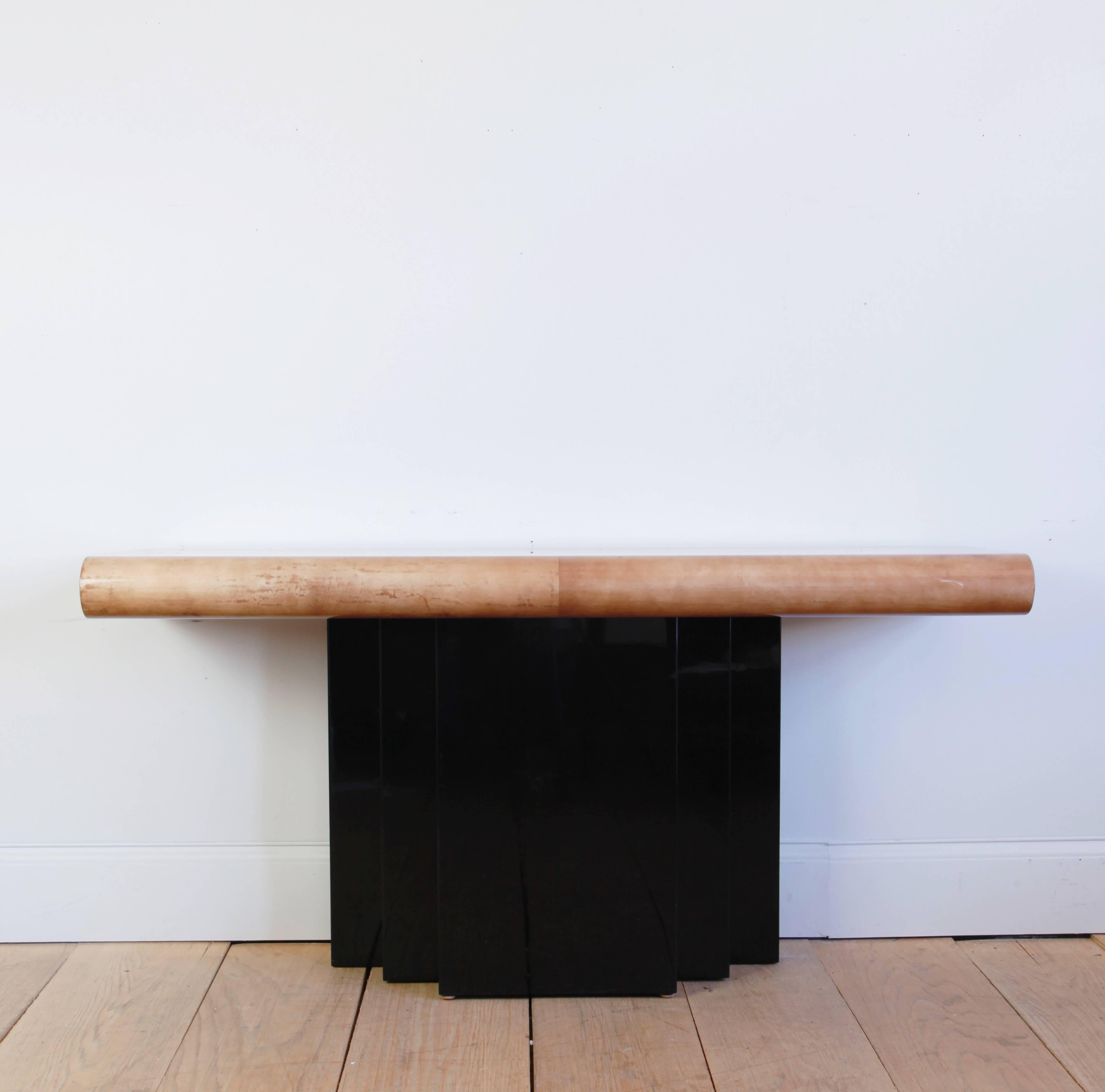 The label on this console table indicates it was a unique piece, custom-made. Goatskin covered rectangular top with a curved edge, on a stepped, black lacquered base.