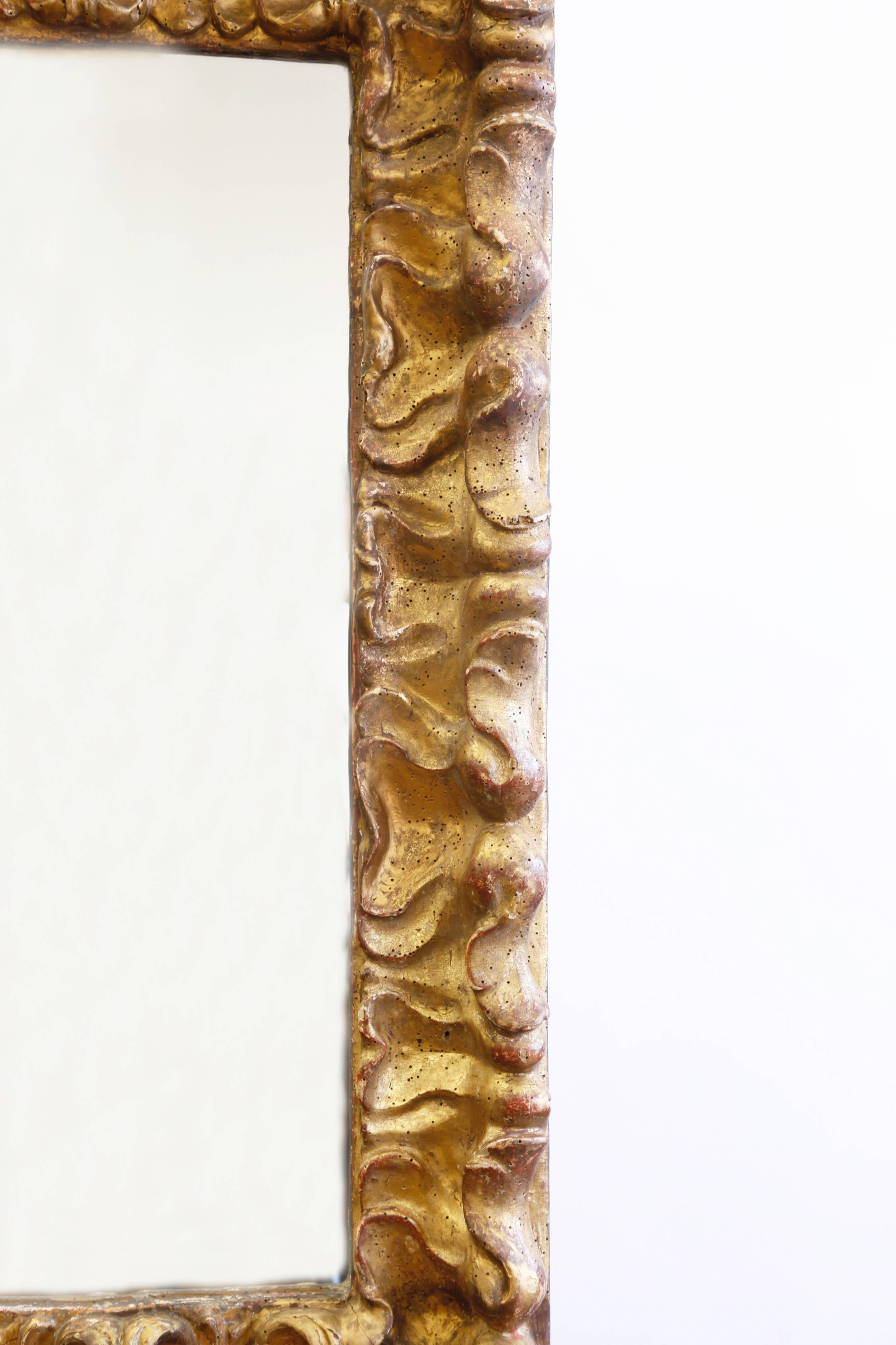 A handsome wall mirror with sinuous Baroque carving.