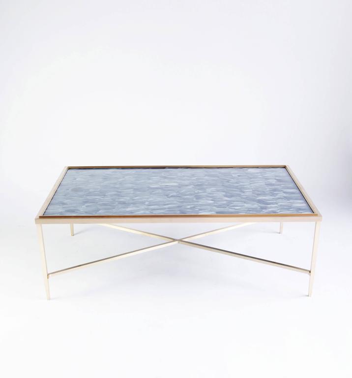 A new variation on the theme of our custom Daedalus table. In this version, the frame (fabricated in Williamsburg, Brooklyn) is unlacquered brass. Under glass, we have arranged rows of grey goose feathers. 

The Daedalus table is inspired by the