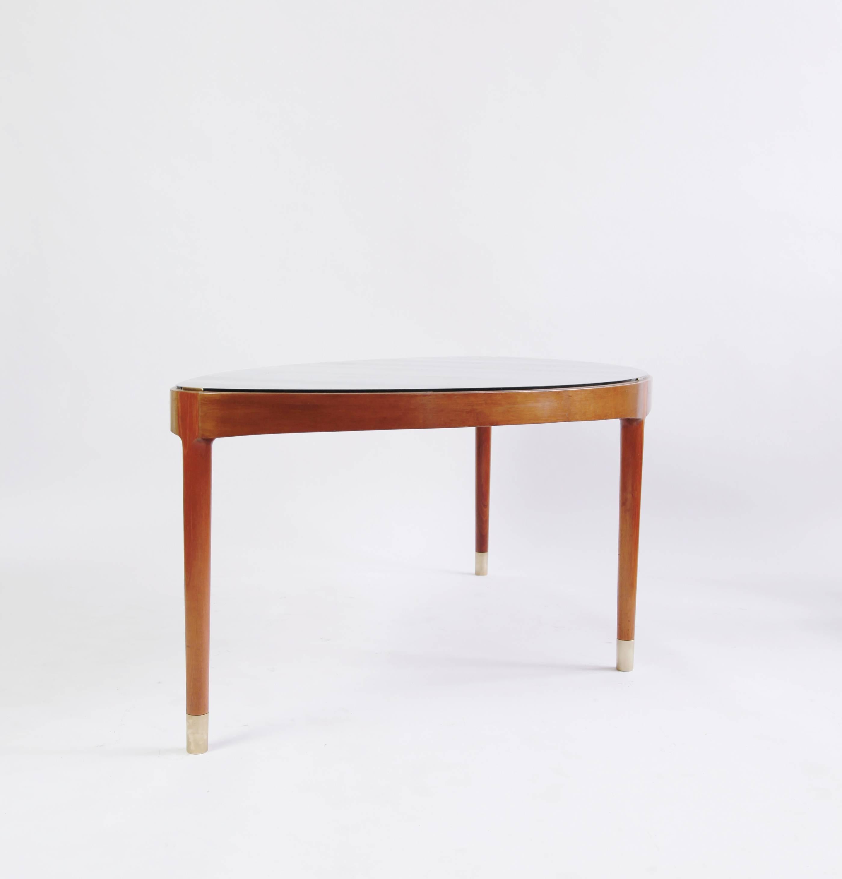 Vestergaard Jensen's work is highly coveted by collectors due to its thoughtful details and seriousness of execution. This is a rare design: the slim, modern profile is coupled with a generous surface area. The thin glass top is held in place with