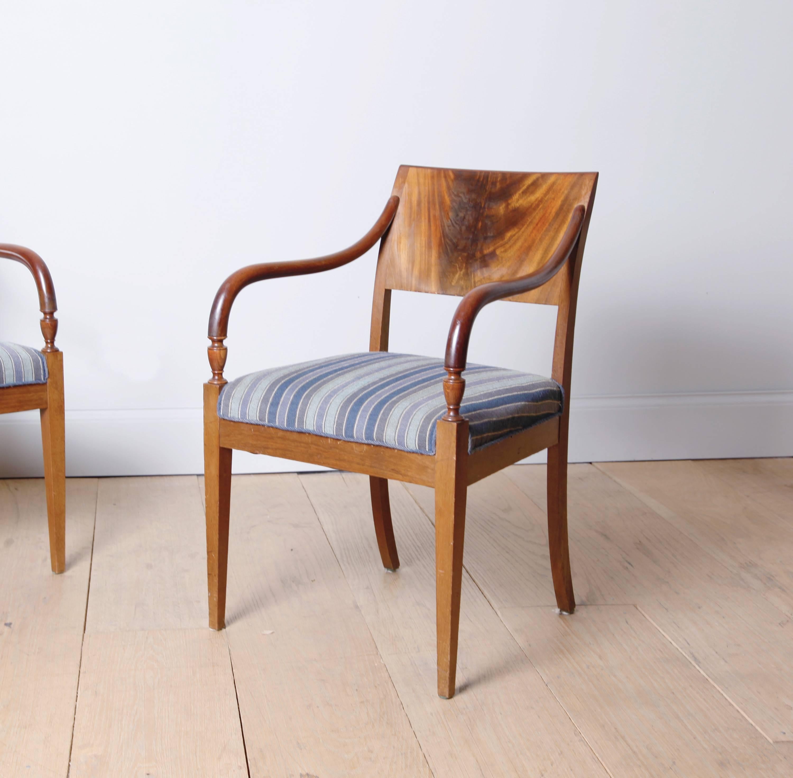 A pair of armchairs with a graceful profile. Fully restored, with original wool needlepoint upholstery.