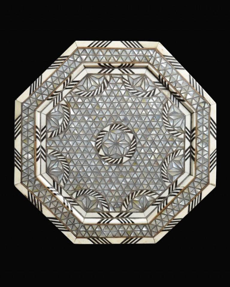Mother-of-pearl bone and silver inlaid coffee table of octagonal form, standing on eight arched bracket-form legs, decorated throughout with geometric interlace in mother-of-pearl, silver and bone.

Dimensions:

Height 18.5 inches.

Width 13.5