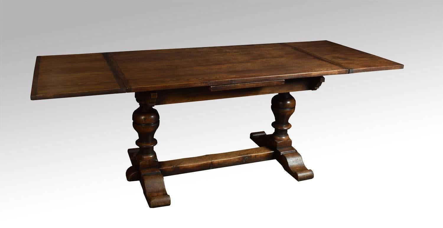 Oak draw-leaf refectory table, the rectangular solid oak top above two pull-out ends, above lobed carved bulbous supports united by a stretcher (will seat ten people).

Dimensions:

Height 30.5 inches,

length 54 inches when open 90