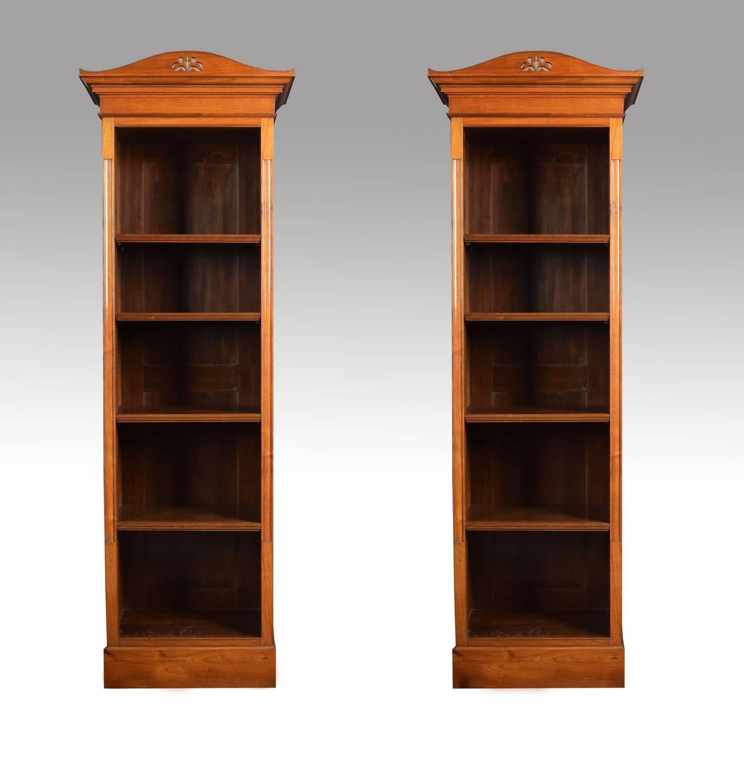 Pair of walnut narrow open bookcases, the top section having pierced cornice above four adjustable shelves, flanked by moulded columns. All raised up on plinth base.

Height 71.5 inches.

Width 23.5 inches.

Dept 14.5 inches.