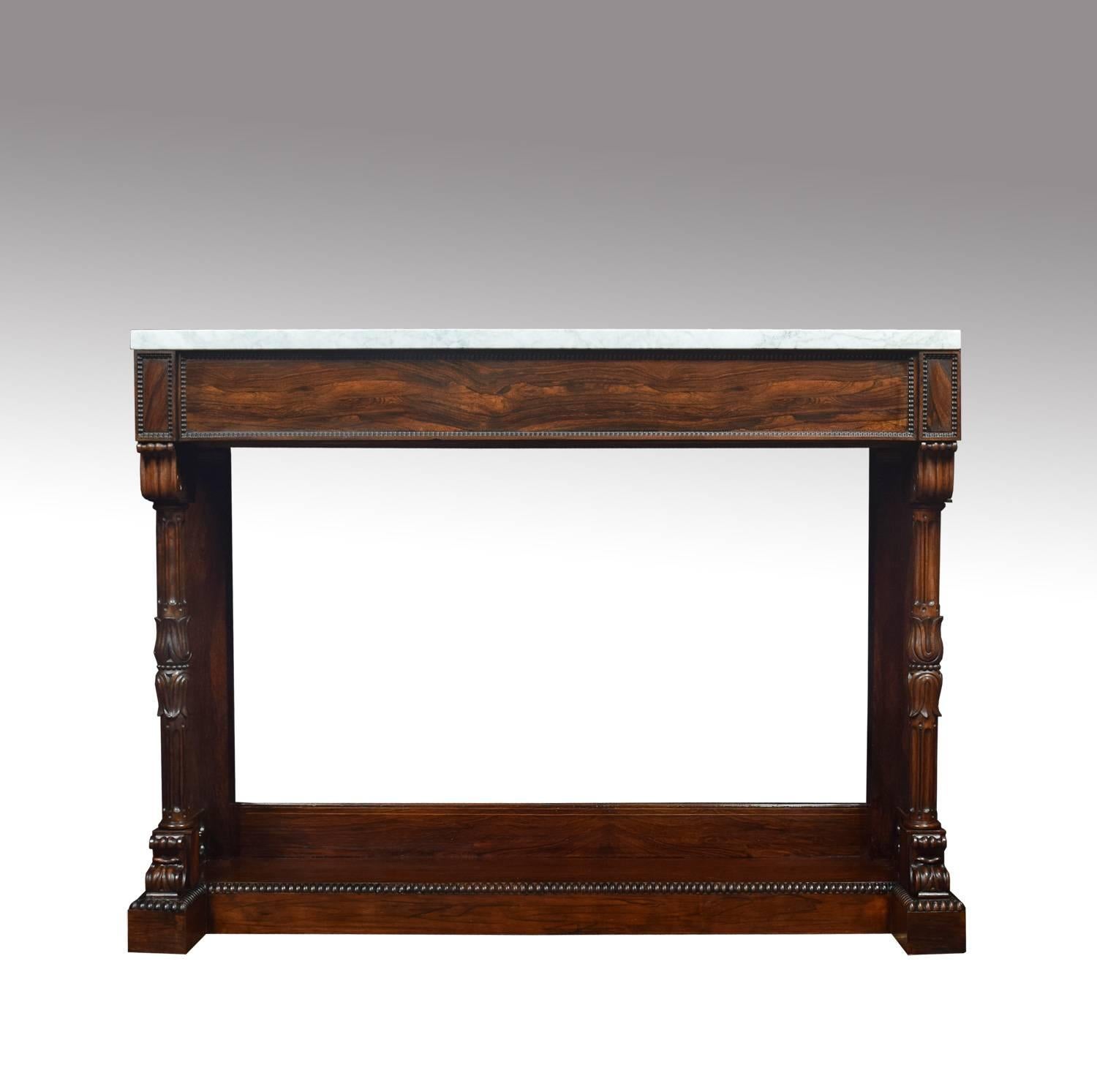 Regency rosewood console table, the rectangular white veined marble top above moulded freeze raised on a pair of turned tulip headed supports united by plinth base.

Dimensions:
Height 41 inches.
Width 54.5 inches.
Depth 16.5 inches.