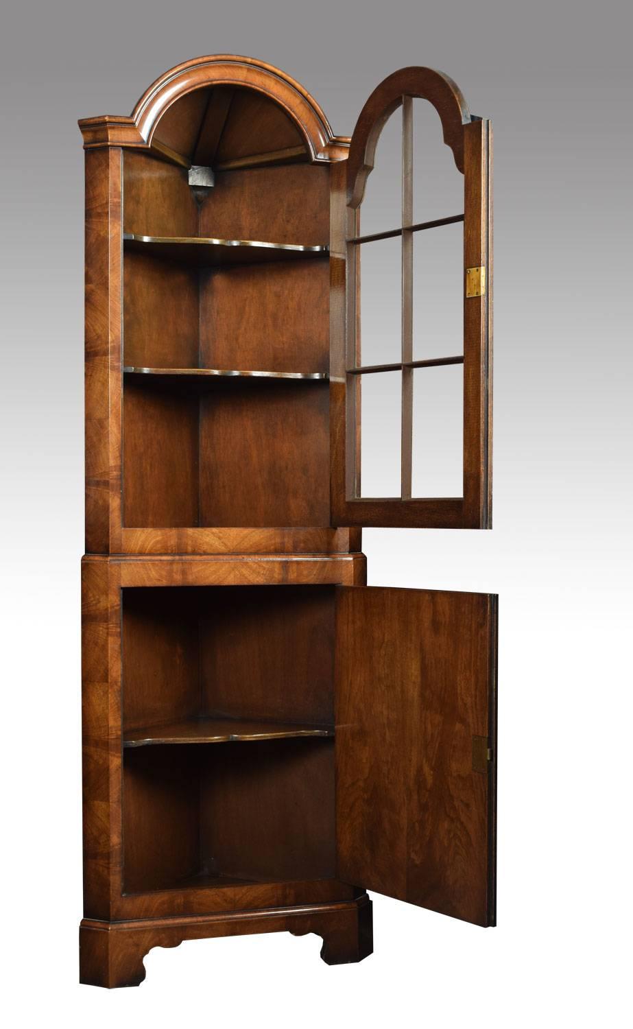 Walnut floor standing corner cabinet, the dome top above single glazed door enclosing two fixed shelves to the base section with a panelled cabinet door opening to reveal single fixed shelf all raised up on bracket feet.
Dimensions:
Height 71.5
