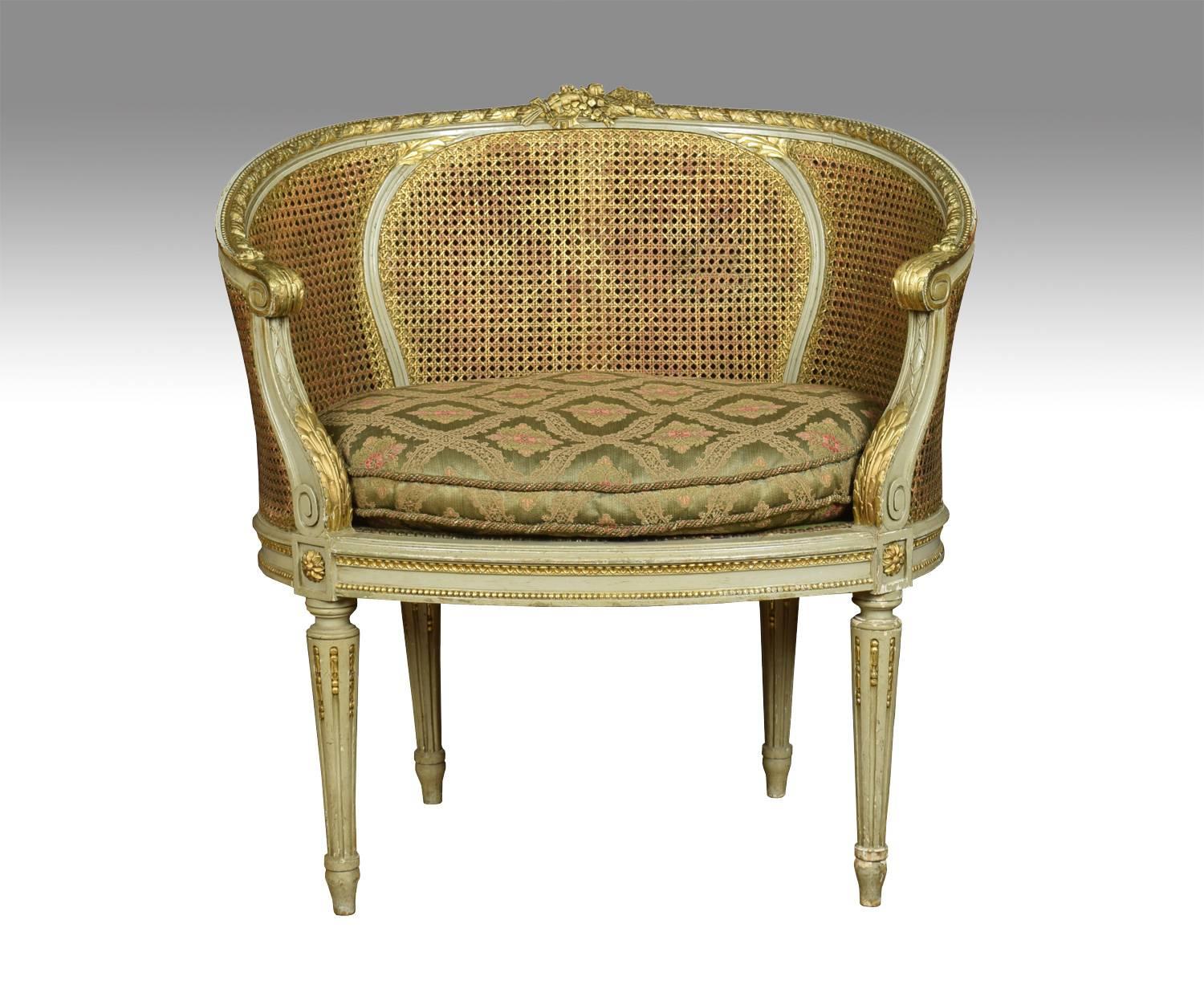 Pair of French Louis XVI style tub armchairs, the carved rails in the typical manner of the period with highly detailed ribbon work along the crest among foliage, the frames with a repeating motif of detailed leaves. To the scrolling acanthus caped