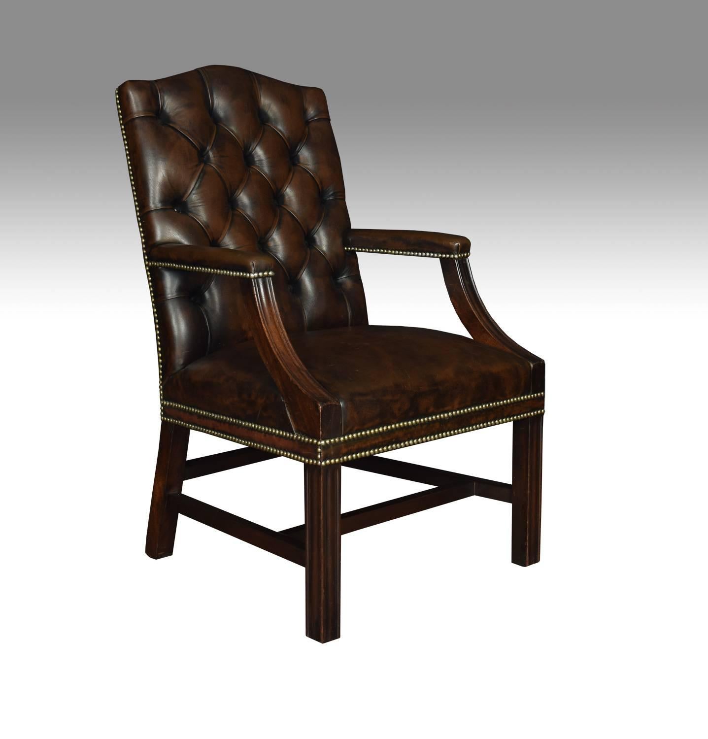 Pair of Georgian style leather Gainsborough, library chairs antique armchairs, having deep buttoned brown leather backs and overstuffed seats with brass studded edges. The solid mahogany framed standing on square legs, united by