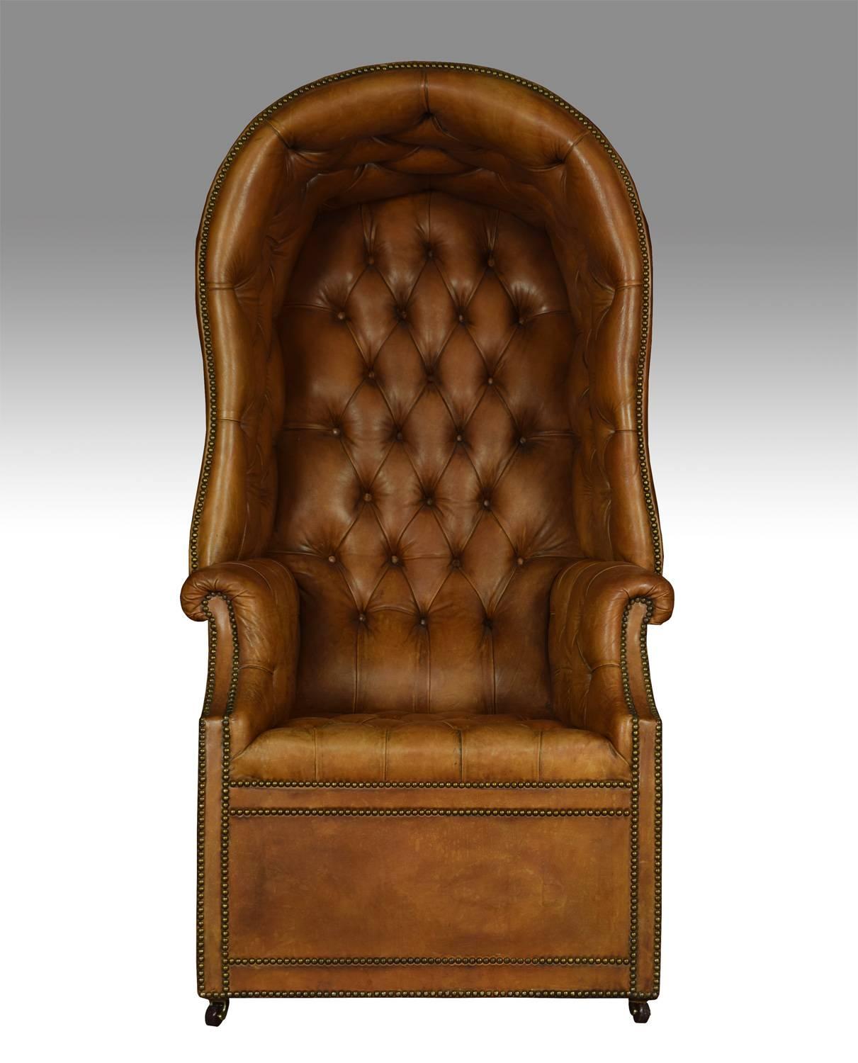 Regency style hall porter’s chair the domed top, back, sides and seat covered in close-nailed brown leather, the back and seat deep buttoned, on castors.

Dimensions
Height 63 inches height to seat 18 inches
Width 32 inches
Depth 33 inches.