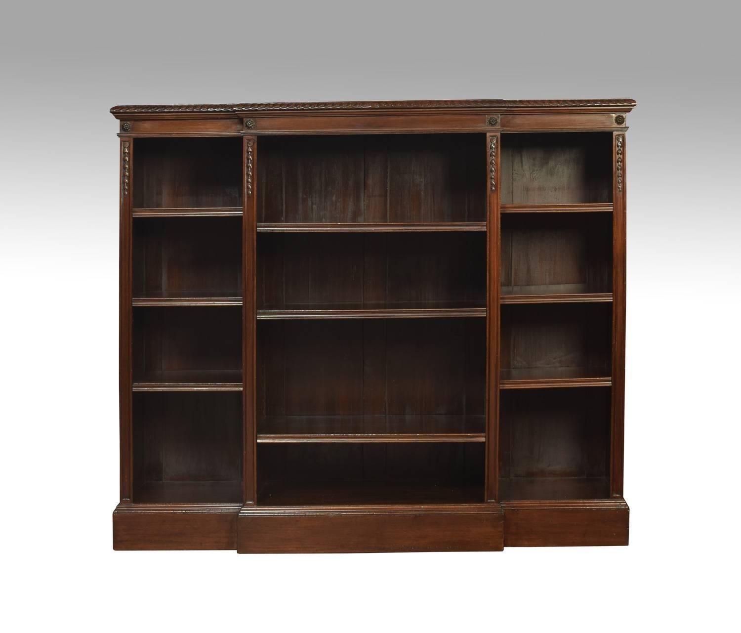 Large mahogany breakfront open bookcases, the projecting carved moulded top above three bays of adjustable shelves each section having three adjustable shelves, flanked by foliated capitals. All raised up on plinth base.
Dimensions
Height 48.5