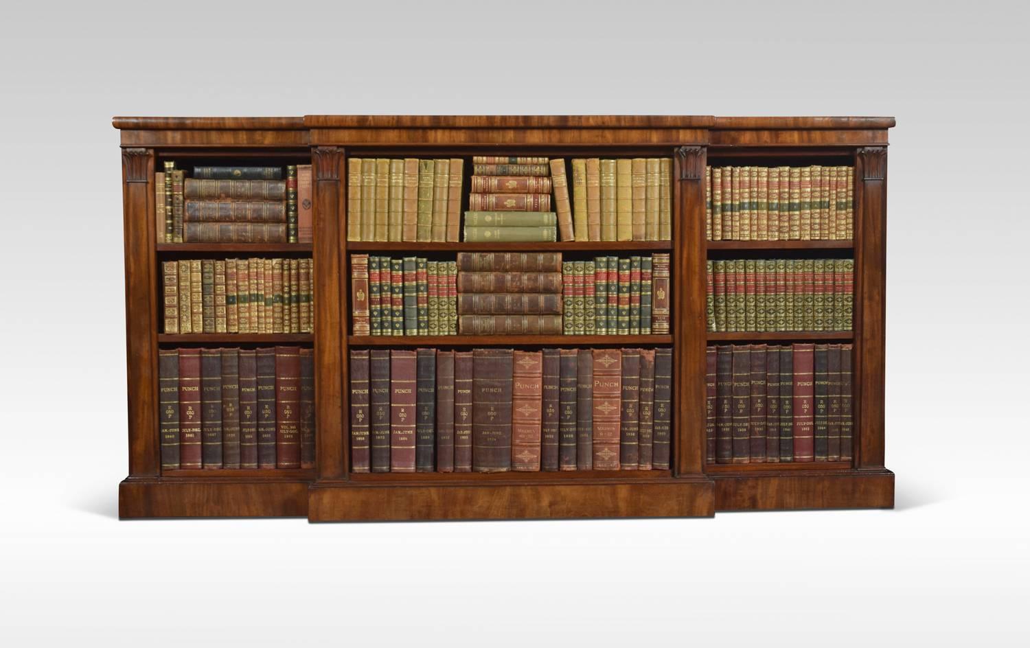 William IV open bookcase, the rectangular breakfront top above three bays of adjustable shelves, divided by carved column pilasters raised up on plinth base.

Dimensions
Height 36.5 inches
Width 72 inches
Depth 17.5 inches.