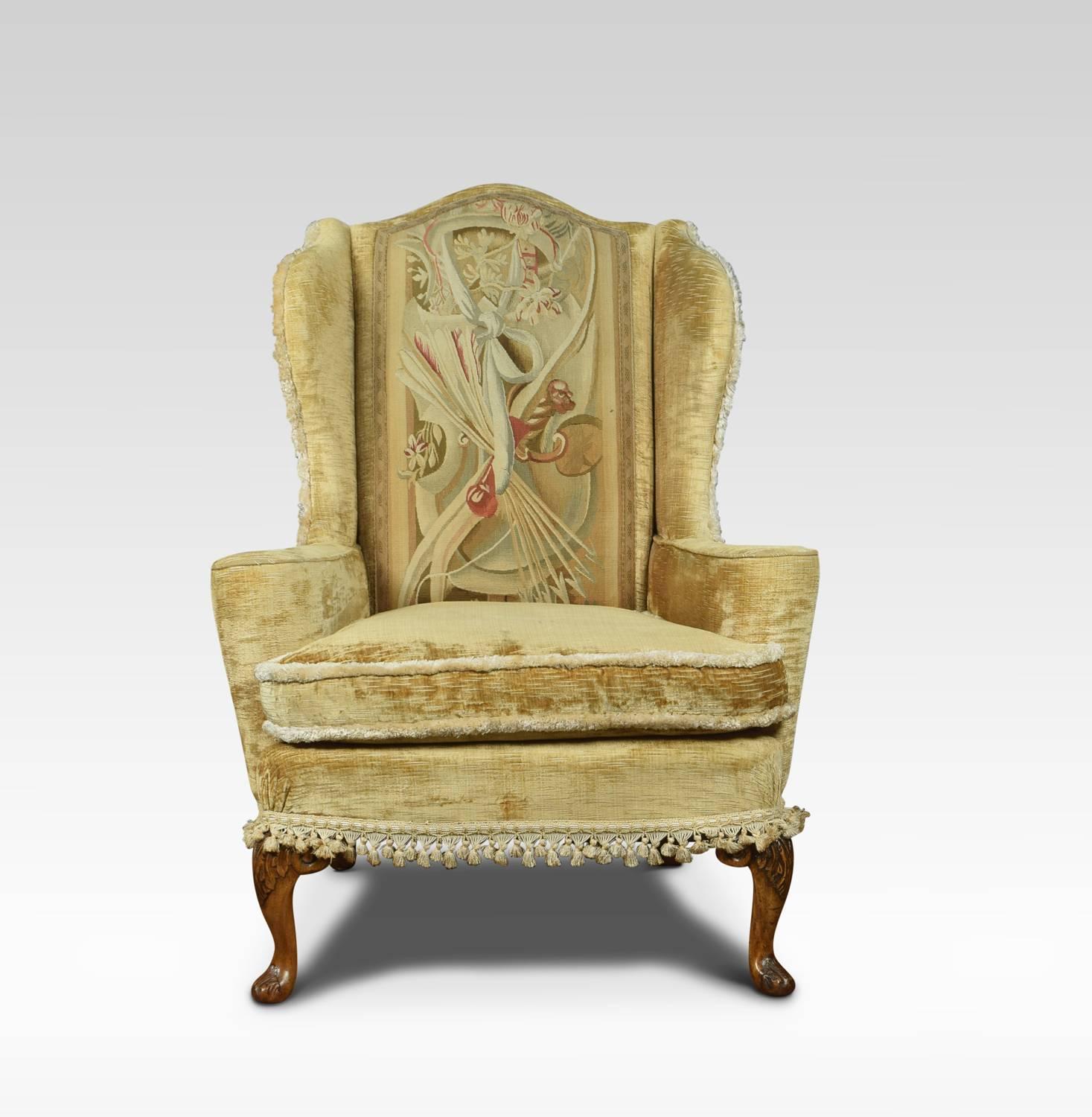 A pair of Queen Anne style wingback armchairs the shaped backs having needlepoint upholstered tapestry back panels, above out swept arms. Raised up foliated carved squat cabriole legs with conforming carved toes.
Dimensions
Height 43 inches Height