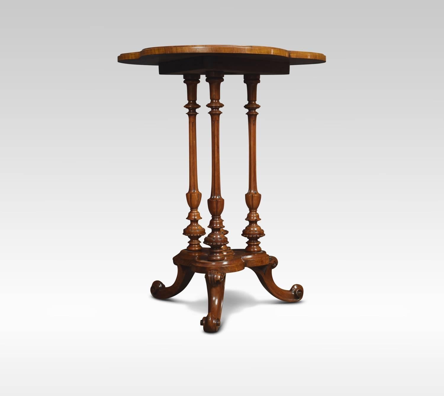 Victorian walnut tripod table, the cloverleaf burr walnut top above three turned and reeded supports united by shaped platform. All Raised up on three scrolling legs.

Dimensions:
Height 26 inches
Width 21.5 inches.