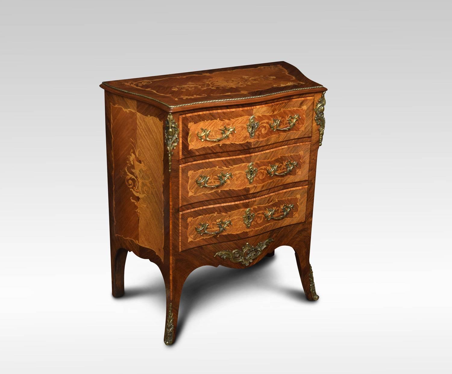 Kingwood and rosewood marquetry commode of Louis XV style, late 19th century, the floral marquetry inlaid top and conforming side panels with gilt metal mounts. Above unusual secretaire draw with inset burgundy tooled leather writing surface, having