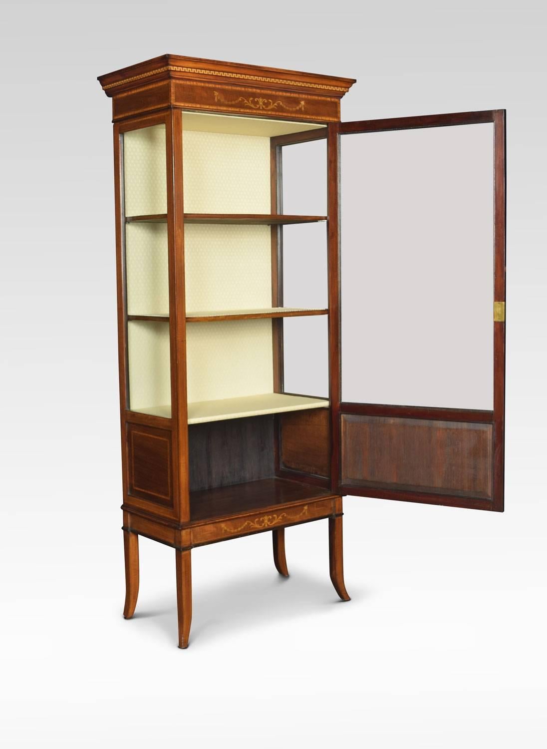 Mahogany Sheraton Revival display cabinet, the rectangular moulded top over inlaid freeze, having large glazed door below. Opening to reveal an upholstered shelved interior. All raised up on four splayed supports.
Dimensions
Height 70.5