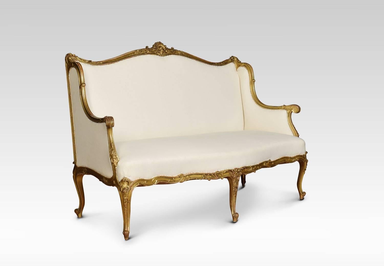 Louis XVI style giltwood settee, the shell carved scroll frame with sweeping arms to the stuff over seat which is finished in a calico ready to be upholstered in fabric, to the C scroll carved frieze. All raised up on slender cabriole