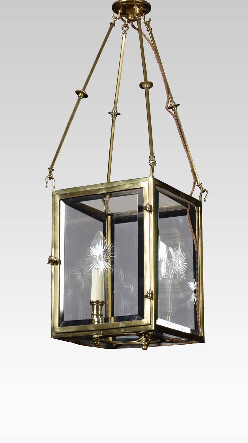 A set of three gilt brass square section hall lanterns, fitted with three lights enclosed by cut glass panels.
Dimensions:
Height 29.5 inches
Width 10 inches
Depth 10 inches.