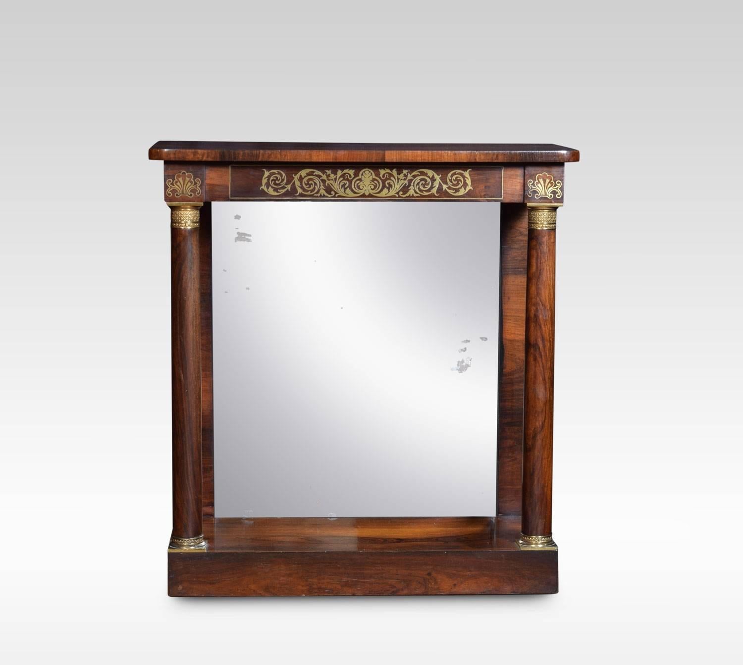 Regency rosewood pier table, of attractive small proportions, having rosewood top with rounded corners. above brass inlaid scrolling freeze, raised on ormolu-mounted circular columns, and original mirrored back. All raised up on plinth