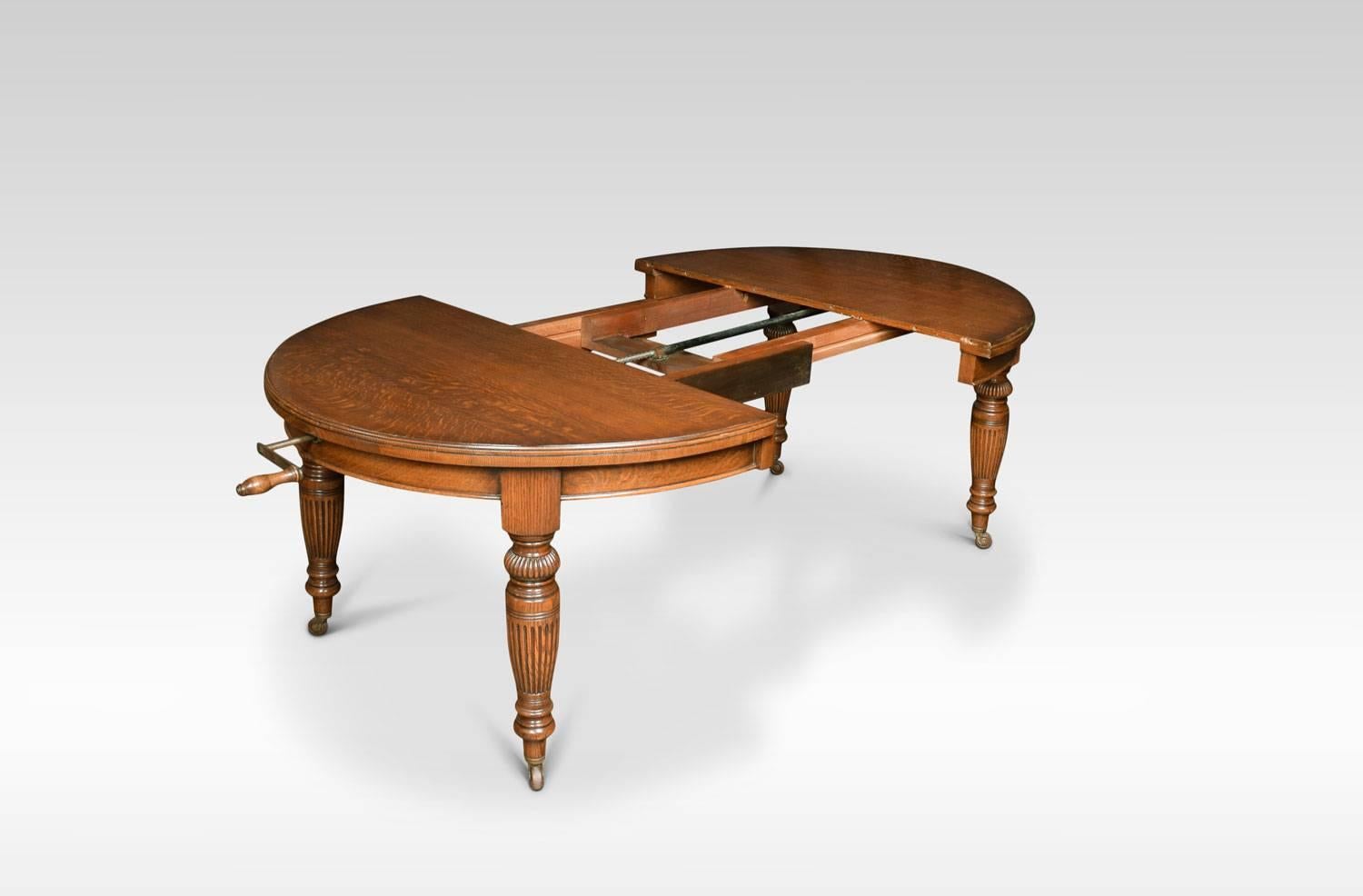 Victorian oak extending dining table, the oval top fitted with telescopic action opening to incorporate two original additional leafs, on turned tapering and reeded legs with brass terminals and casters will seat eight-ten.
Measures: Height 29