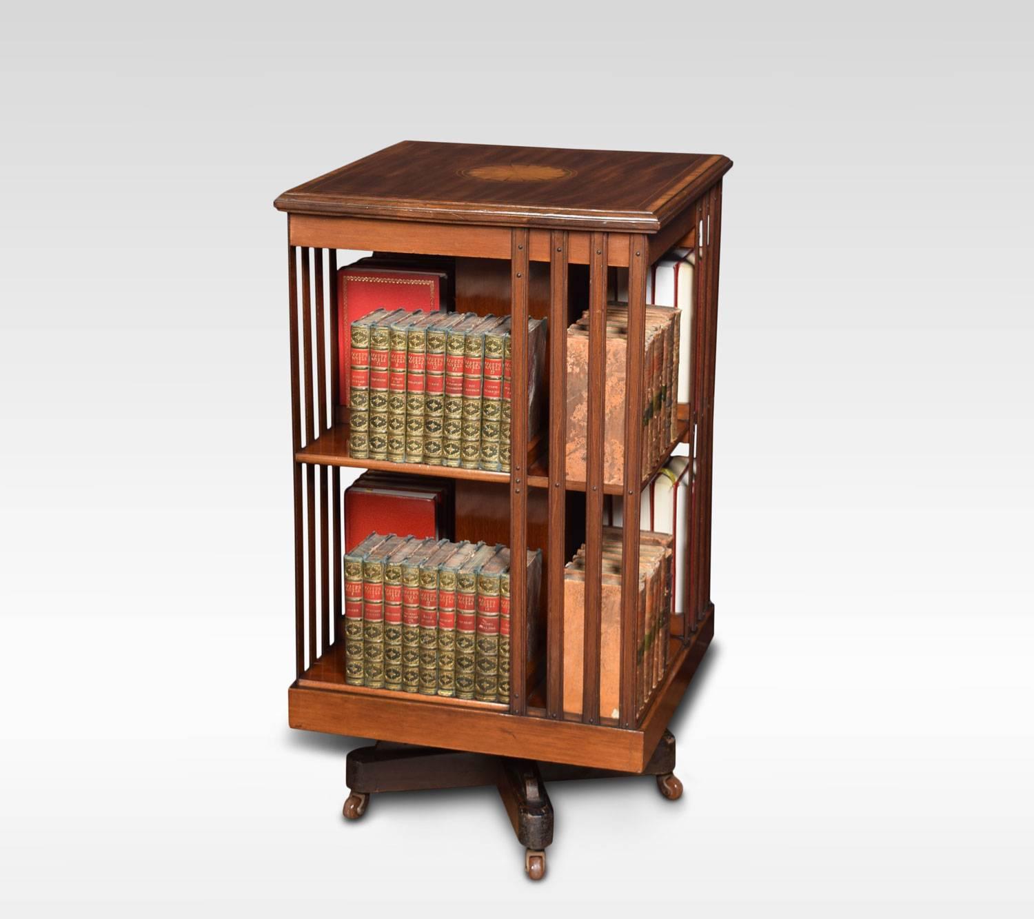 Maple & Co style mahogany revolving bookcase the satinwood crossbanded top with central fan inlay, above an arrangement off shelves raised up on a cruciform base with castors.
Dimensions:
Height 35 inches
Width 19 inches
Depth 19 inches.