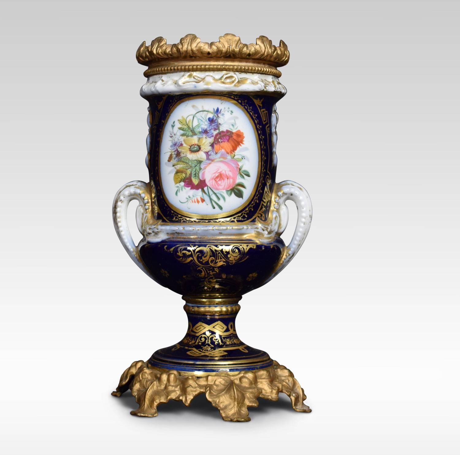 Sevres style twin handle lamp base, hand-painted in cobalt with gold detail. Featuring a central 17th century courting couple the opposing side with floral motifs. Raised up on gilt wood base.
Dimensions
Height 13.5 Inches
Width 7 Inches
Depth 7