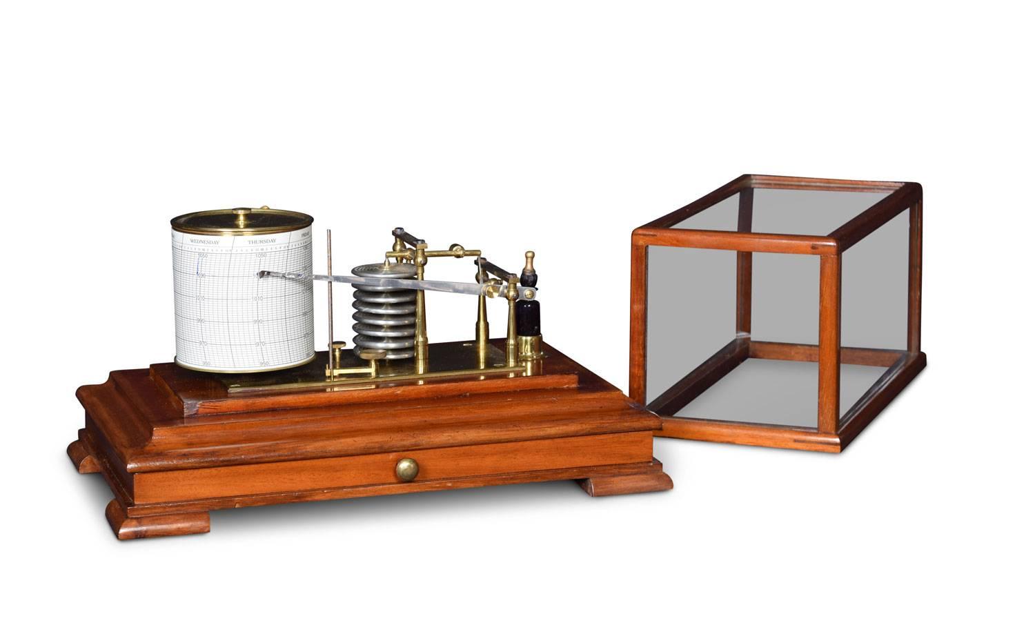 Mahogany cased barograph, having five glazed removable lid, and a drawer below to house the charts. The mechanical eight-day movement is housed in the drum, fitted with a seven-day chart which covers one full rotation of the drum. The ink trace, or