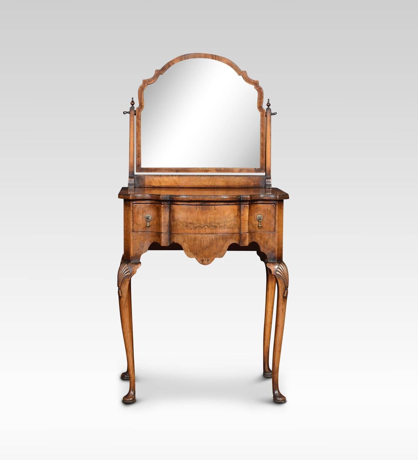 Figured walnut Queen Anne style dressing table, the original mirror plate in moulded frame between square section supports.The base section of serpentine shaped form, with single frieze drawer above a shaped apron. All raised up on shell capped