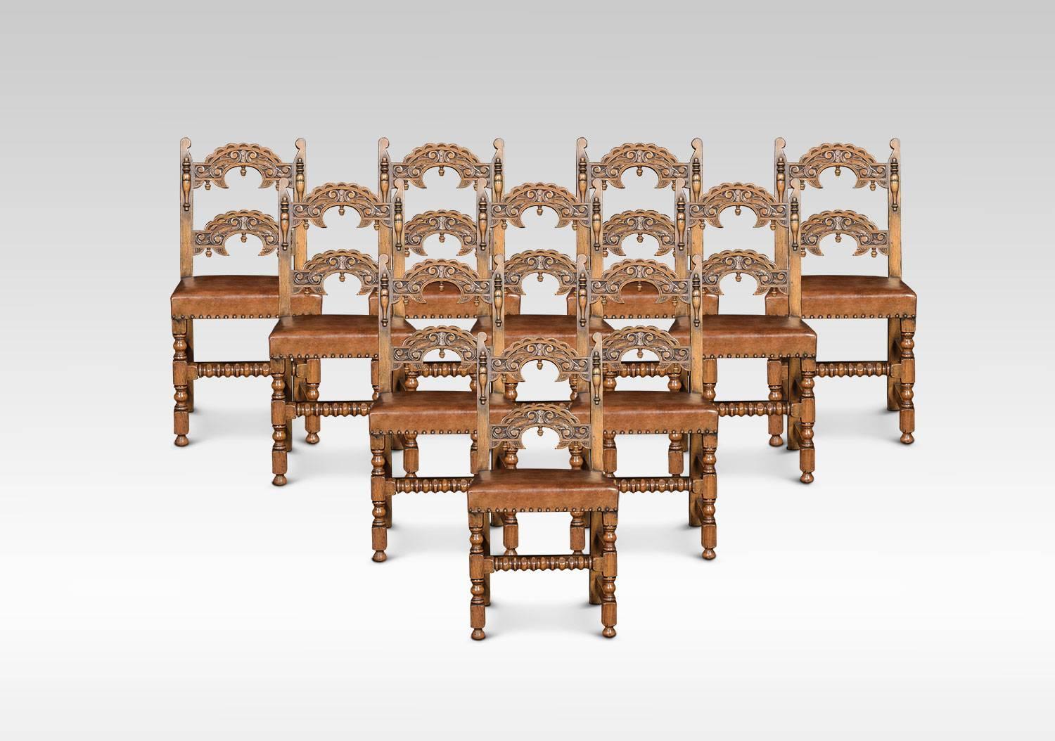 A set of twelve solid oak framed dining chairs, having arched supports with acorn drop finials above leather overstuffed seats with studded edges. All raised up on turned supports united by bobbin stretchers.
Dimensions

Armchairs
Height 37.5 Inches