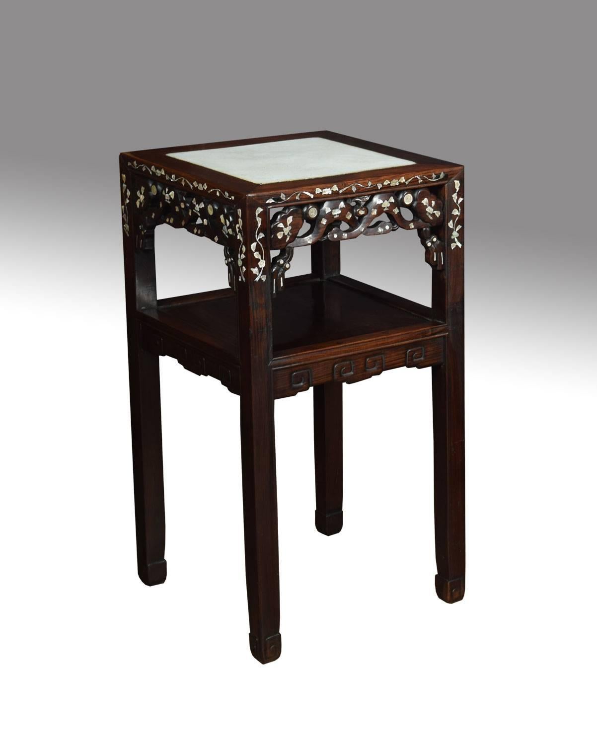 Pair of Chinese inlaid urn stands, the tops inset with white marble, above pierced sides decorated with mother of pearl foliated motifs raised on square supports united by under tier.
Dimension:
Height 31 inches
Width 16 inches
Depth 16 inches.