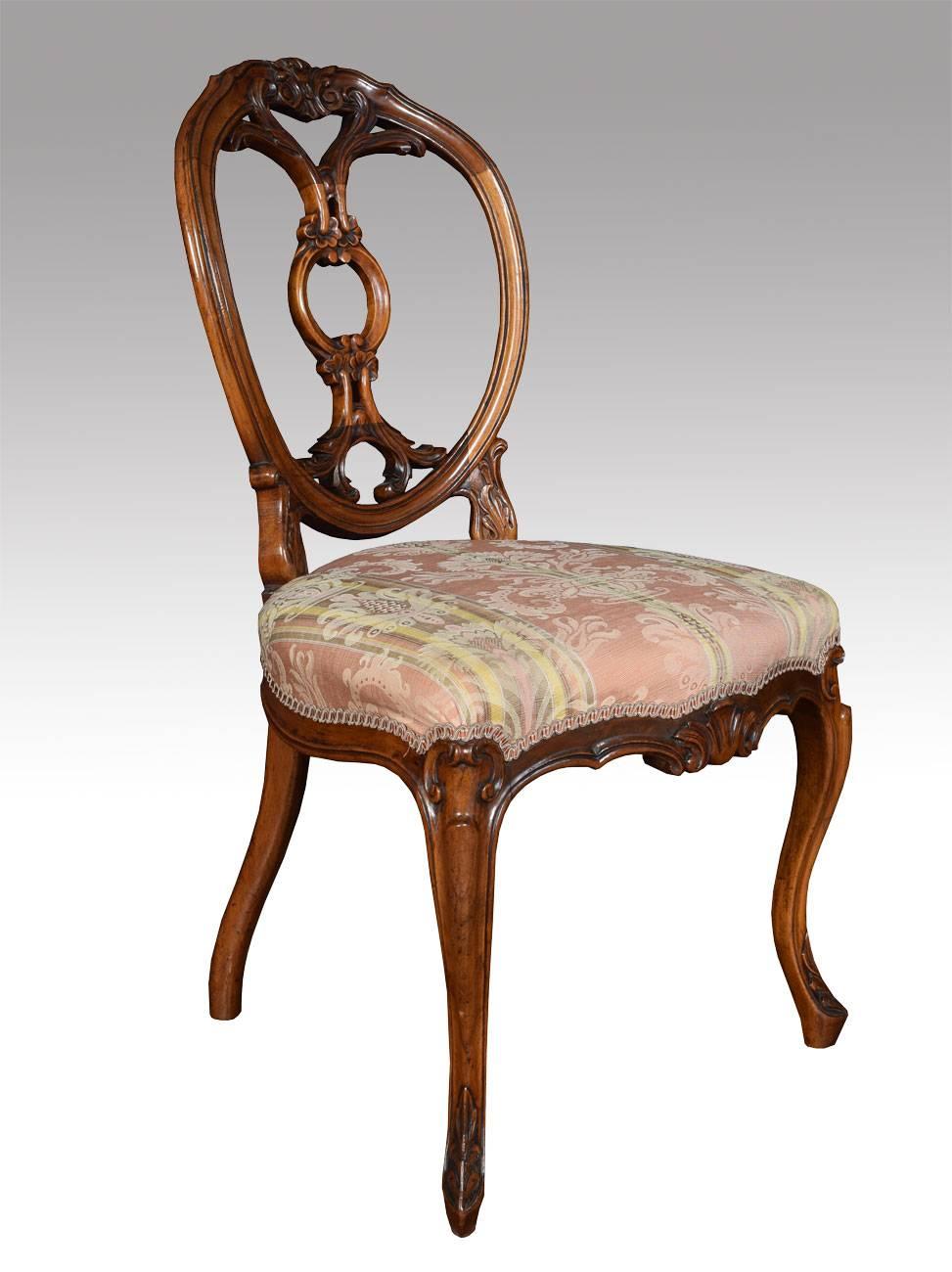 A set of six Victorian walnut dining room chairs with oval shaped backs having delicately cartouche and scroll carved crested center, to the over-stuffed seats, all raised up on shaped cabriole legs.

Dimensions:

Height 36 inches height to seat