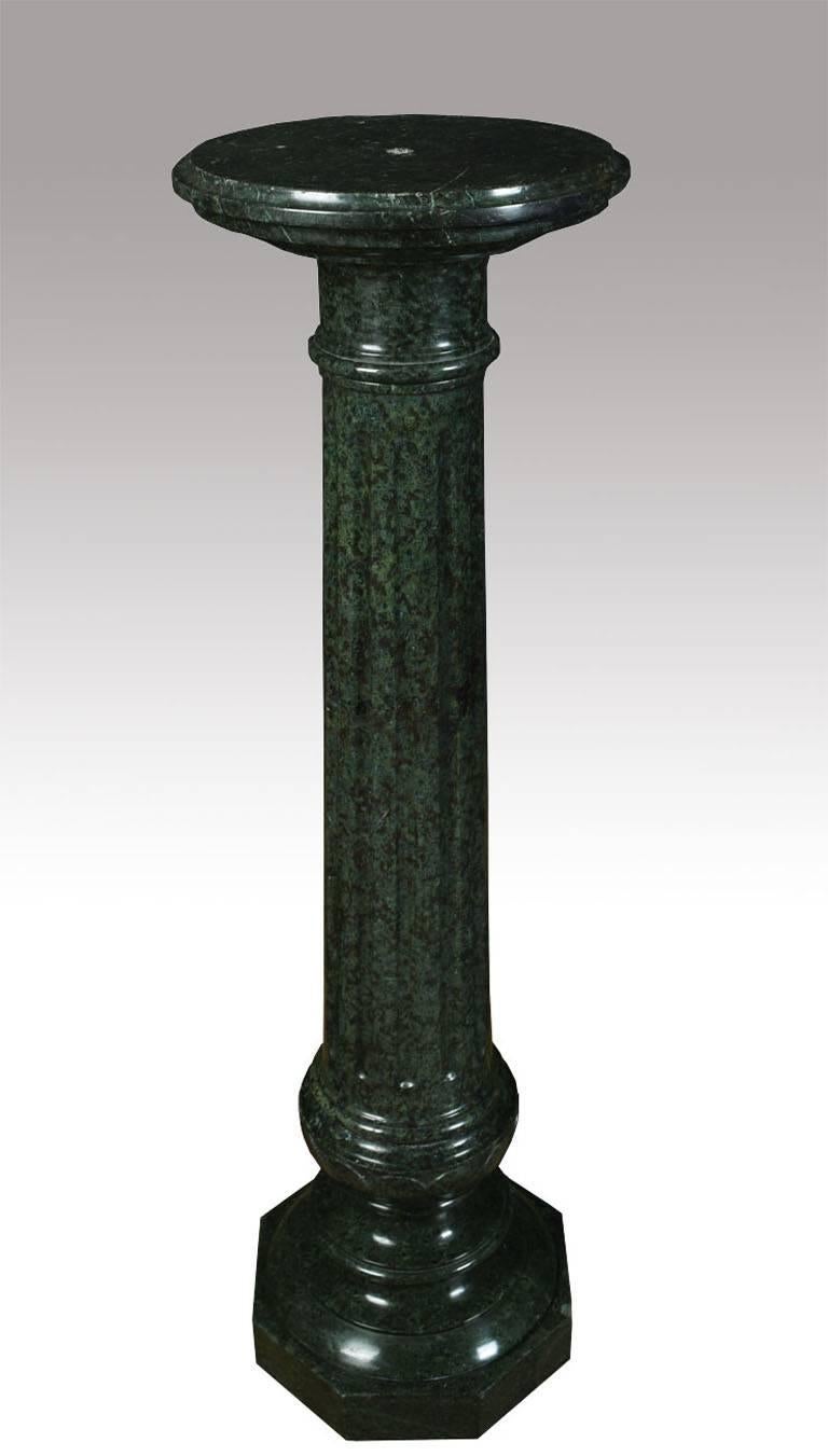Late 19th century serpentine marble column, having circular turned top leading down to a tapered reeded column all raised up on circular and octagonal base.
Dimensions:

Height 45 inches.

Diameter of top 12.5 inches.