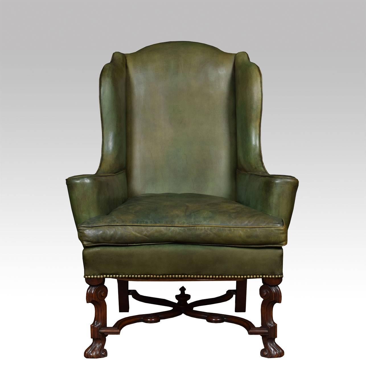 Walnut leather covered wing armchair the arched top, back, arms and seat cushion covered in green leather and all raised up on flemish scroll legs united by under tier

Dimensions

Height 45 Inches Height to seat 19 Inches

Width 32