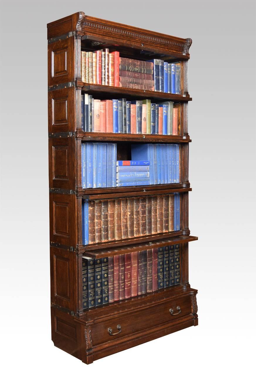 Oak Globe Wernicke sectional bookcase, having five graduated tiers with glazed doors, between fluted pilasters and having panelled sides, raised on a plinth base with single long drawer

Dimensions

Height 74 Inches

Width 35.5 Inches

Depth