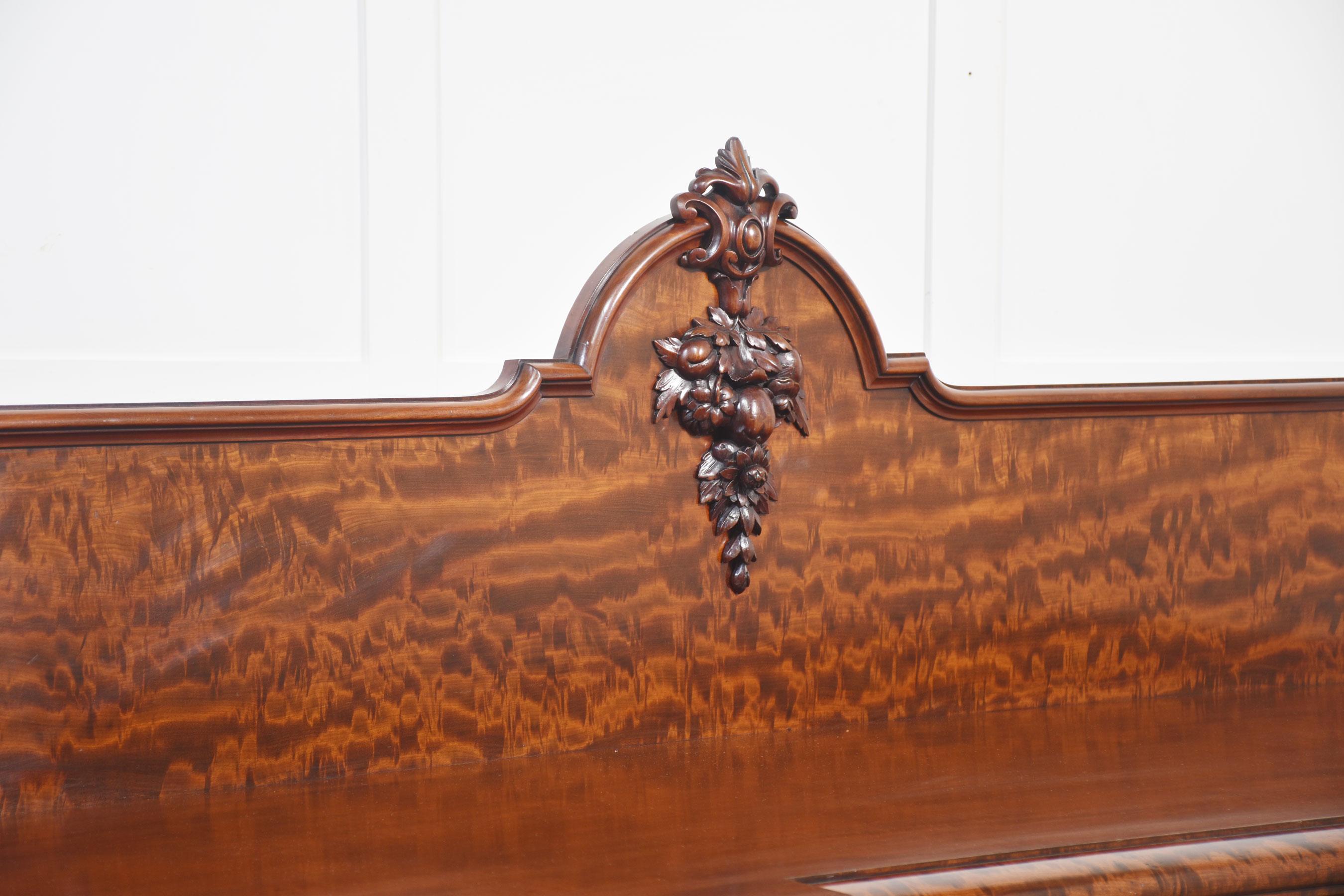 Victorian mahogany pedestal sideboard the ached back with carved leaf decoration to the large inverted breakfront top. To the frieze fitted with three drawers. To the base section, fitted with panneled doors flanked by scrolling columns. The doors