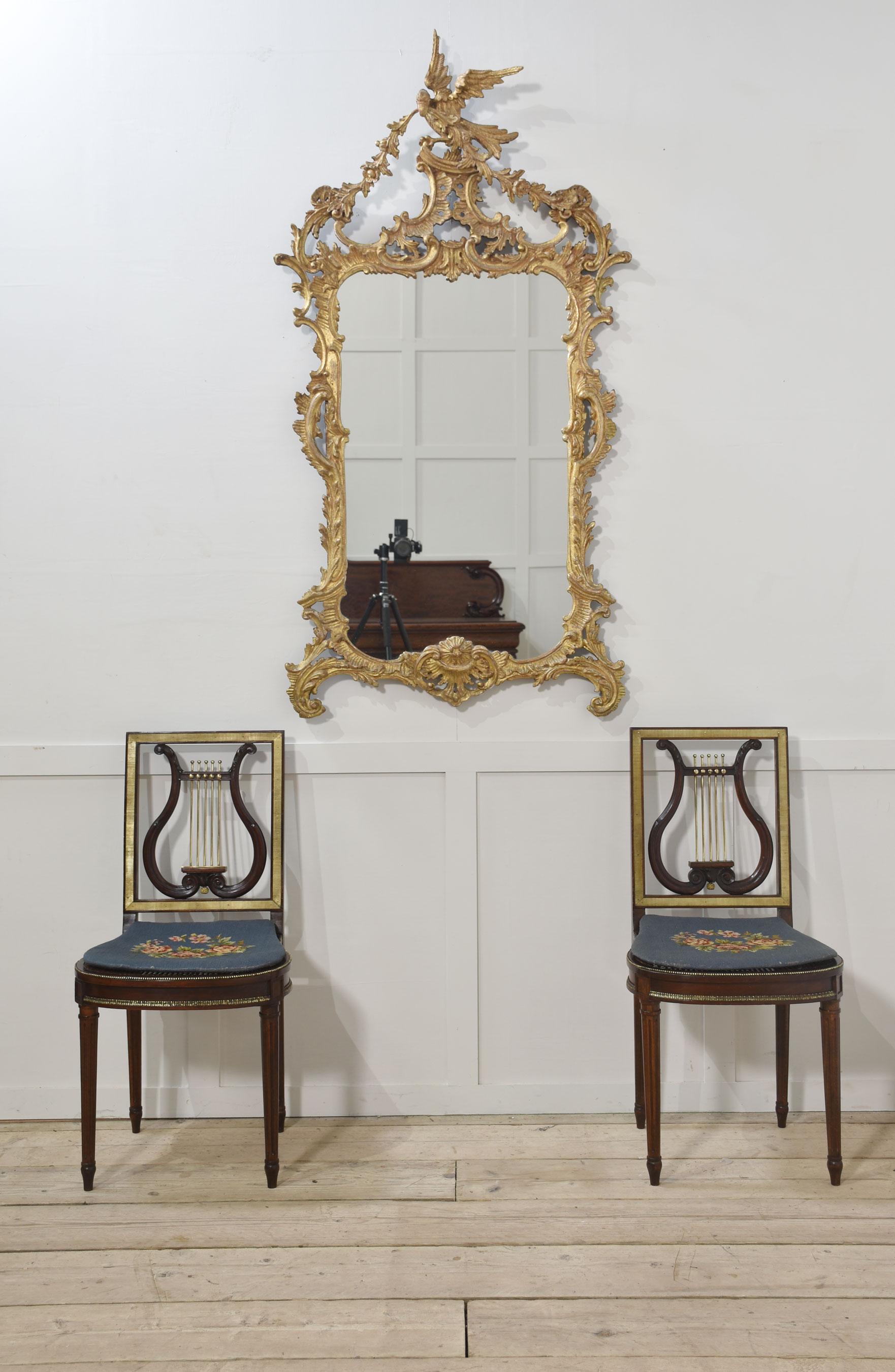 Georgian style gilt Wall Mirrorsurmounted with Eagle holding a garland of flowers, to the scrolling frame with further foliated decoration, surrounding the original mirror plate.
Dimensions
Height 61.5 Inches
Width 32 Inches
Depth 5 Inches