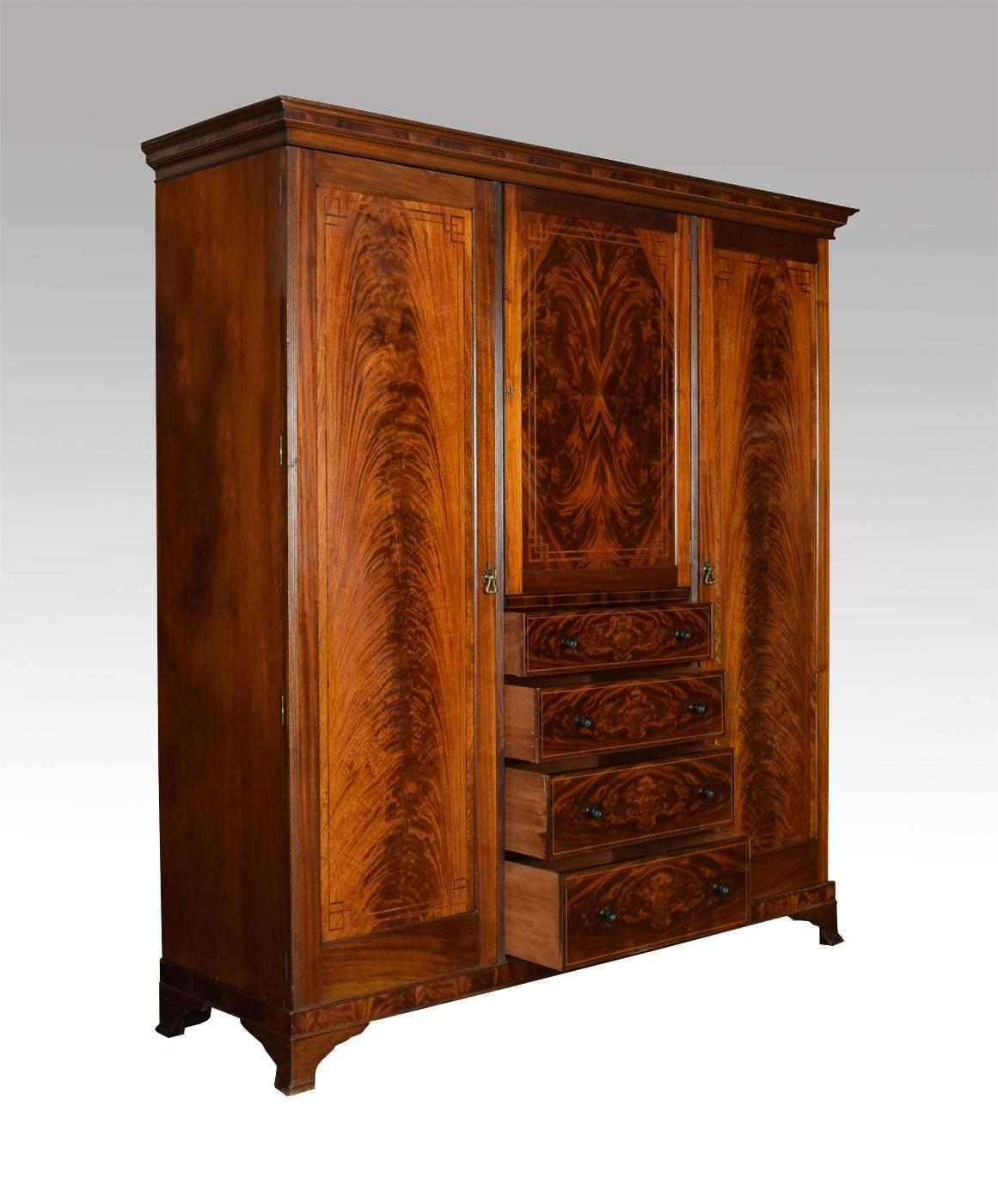 

Late 19th century flame mahogany compactum wardrobe by Maple & Co, the detachable crossbanded cornice above a central door with flame mahogany panel. The door opening to reveal single fixed shelf, above four long graduated drawers with ebony