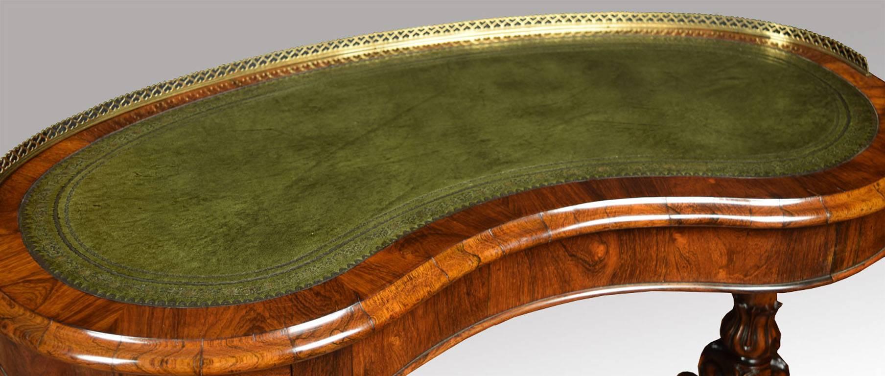 

Victorian lady’s rosewood writing table, the kidney-shaped top with pierced love heart design brass galleried back and tooled and gilded green leather insert writing surface within a moulded edge above a plain frieze with single drawer stamped