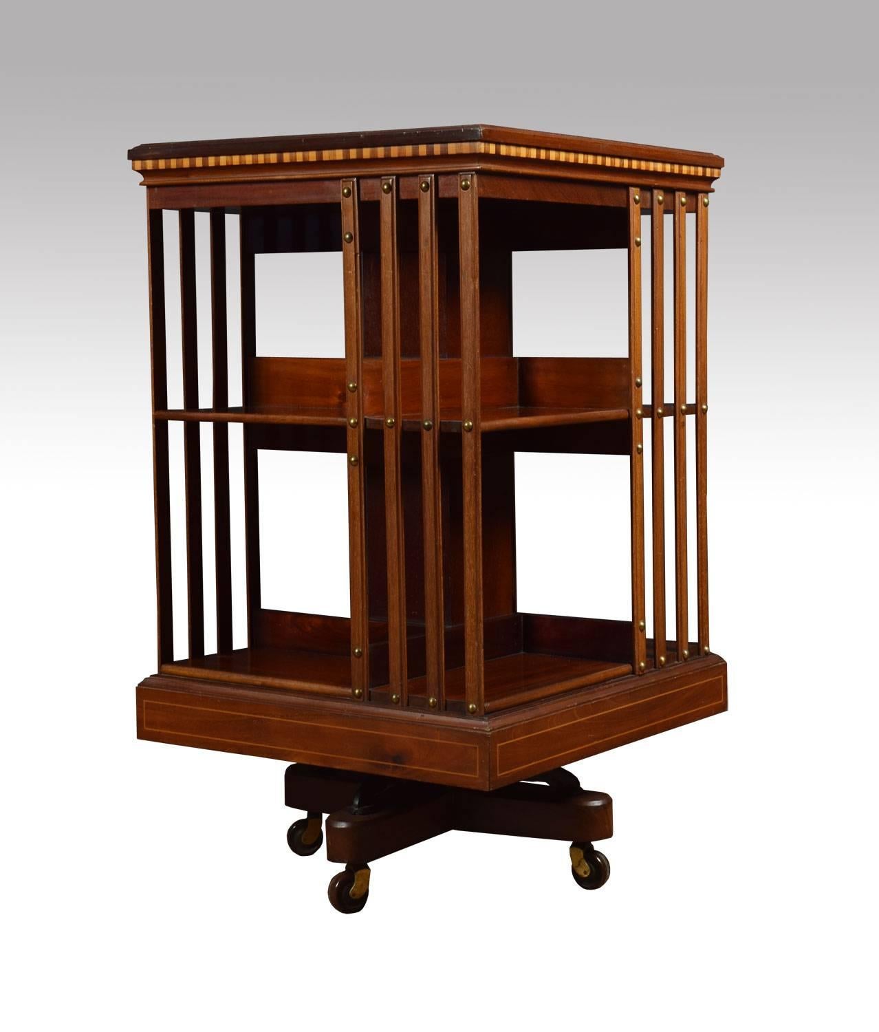 Mahogany revolving bookcase the satinwood crossbanded top with central fan inlay, above an arrangement off shelves raised up on a cruciform base with castors attributed to maple and Co.
Dimensions:
Height 34 inches,
width 20 inches.