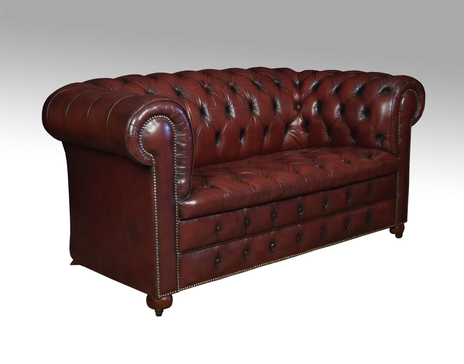 Burgundy two-seat vintage leather Chesterfield sofa on turned front legs with brass ceramic castors, with shaped feet to the back. Good solid condition, the leather is soft, nicely worn in with no rips or tears.
Dimensions
Height 30 inches, height