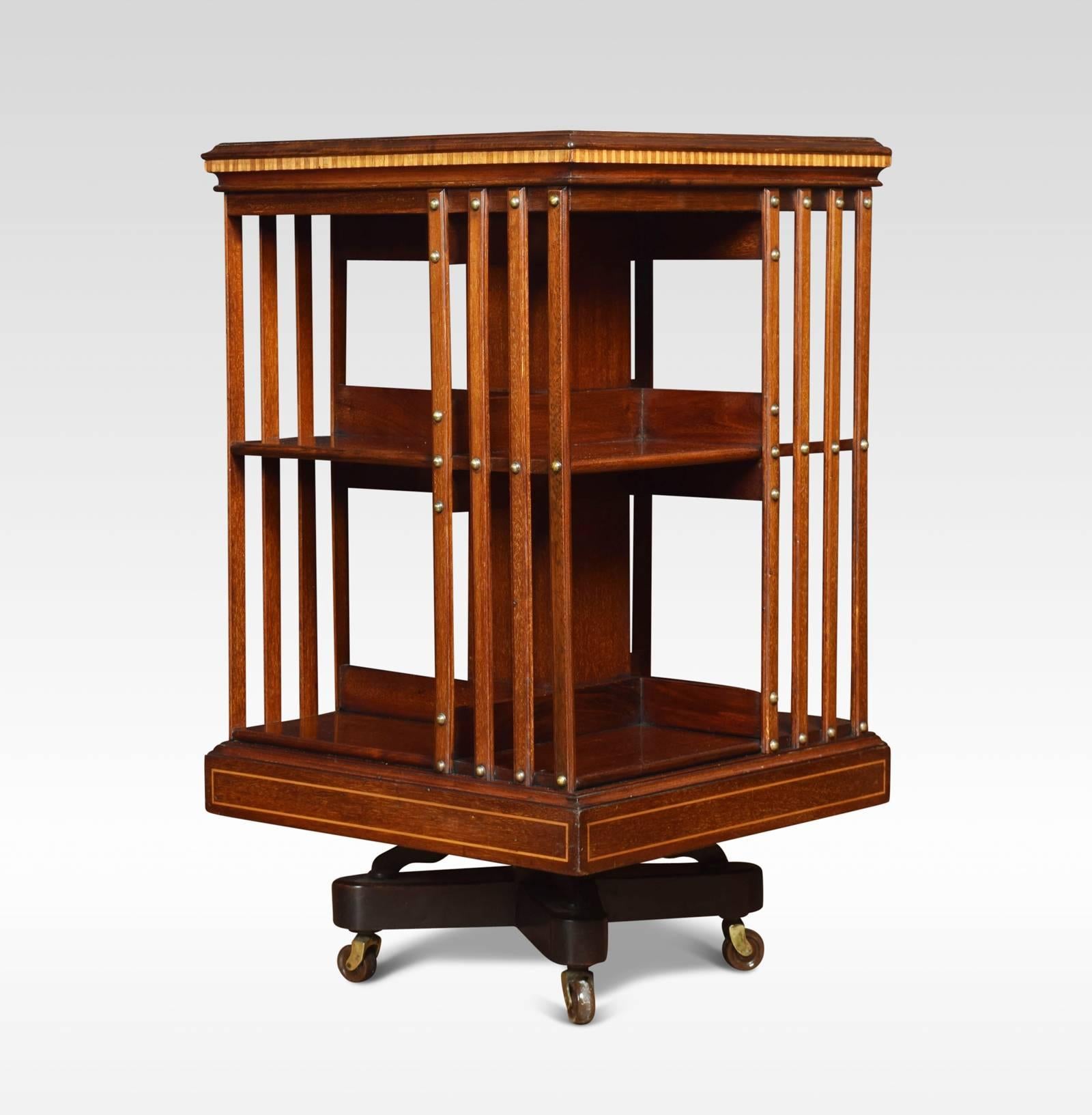 Mahogany revolving bookcase the satinwood crossbanded top with central fan inlay, above an arrangement off shelves raised up on a cruciform base with castors attributed to Maple & Co
Dimensions
Height 34.5 inches
Width 20 inches
Depth 20
