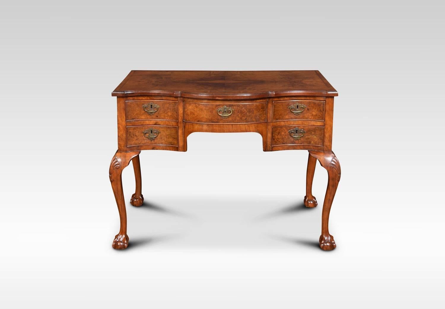Figured walnut Queen Ann style writing desk or dressing table, the large walnut top above an arrangement of five drawers with brass handles. All raised upon on shell capped cabriole legs terminating in claw and ball feet.
Dimensions:
Height 29