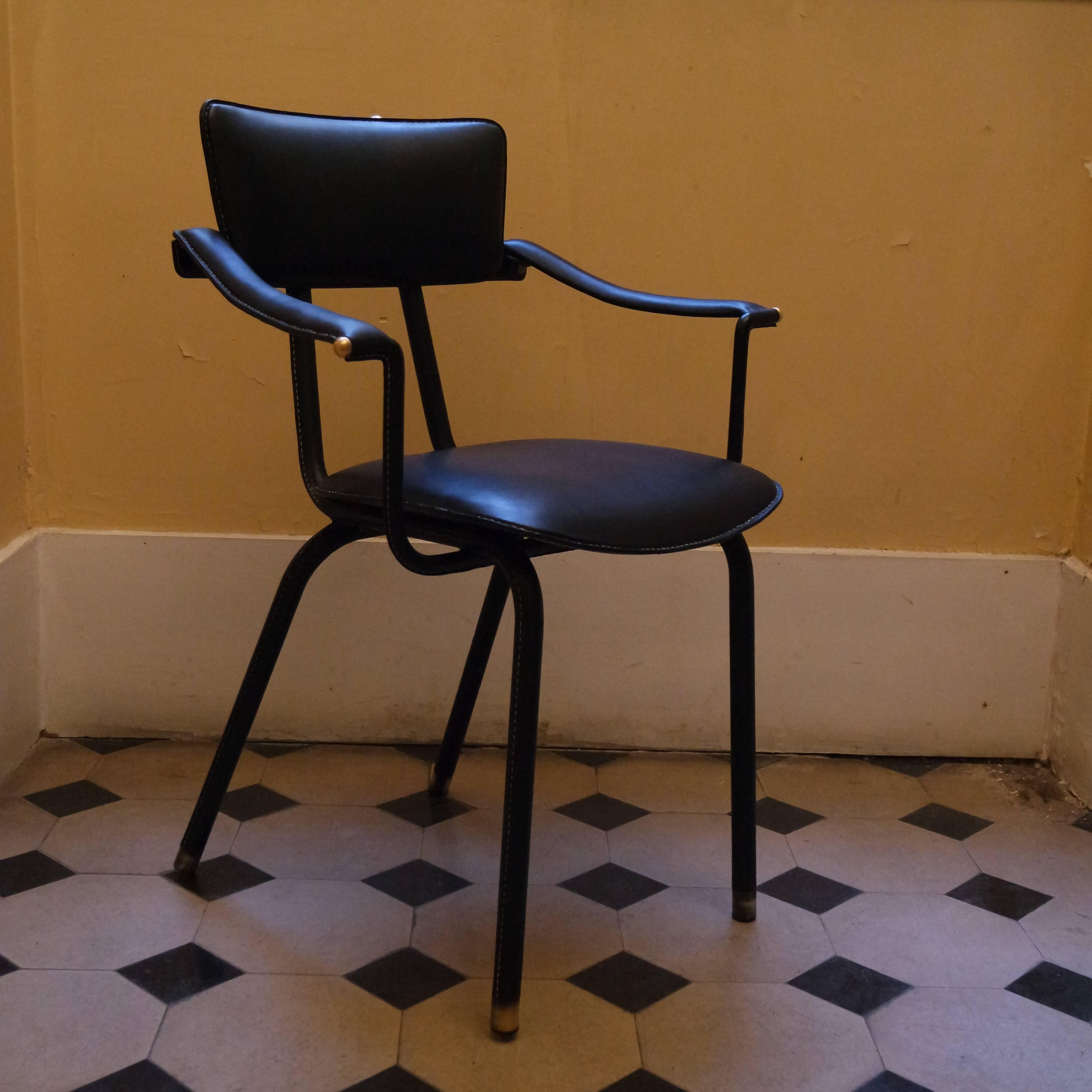 Elegant set of four Jacques Adnet armchairs covered with black leather hand stitched piqué-sellier.