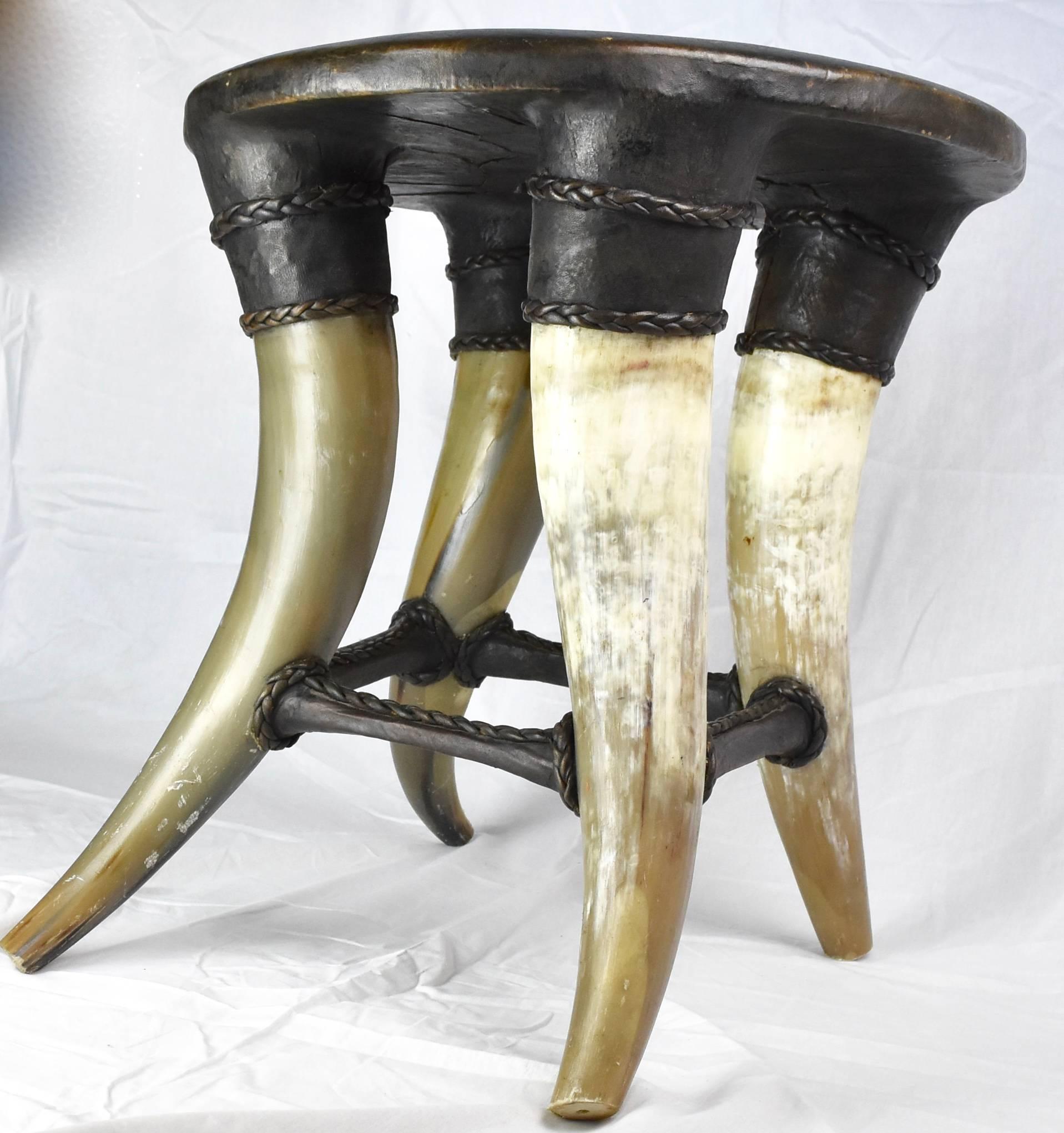 Featured is a beautifully shaped stool with rich leather and 4 horn legs. Notice the and hand sewn stitch detail on the four bases attaching to the horn.
Super Chic for a side table.