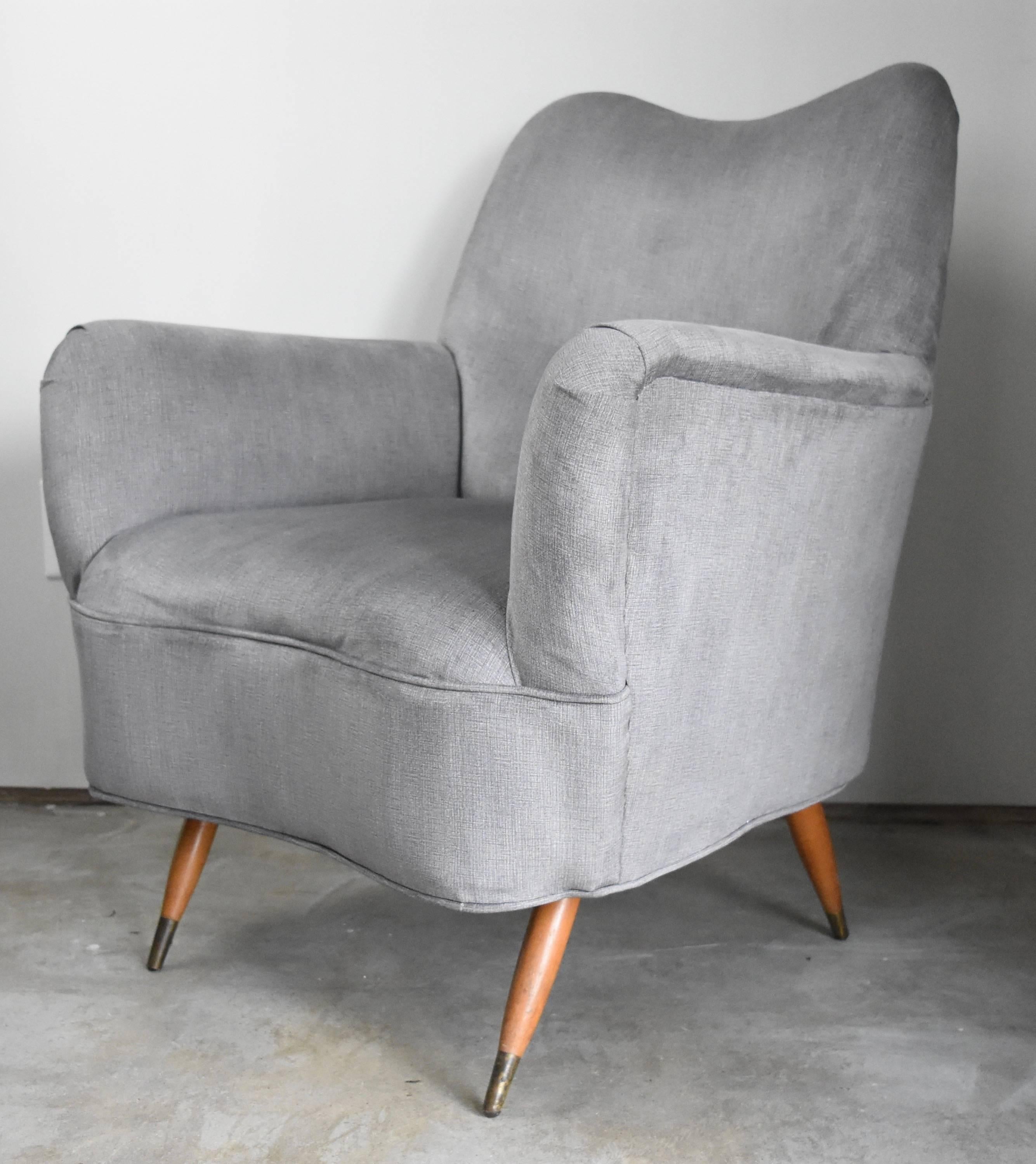 These Mid-Century Modern chairs are newly upholstered in beautiful silver low pile velvet. These are surprisingly heavy and constructed incredibly well. Believed to be Italian. The wear is on the legs where the brass tips have tarnished. Other that