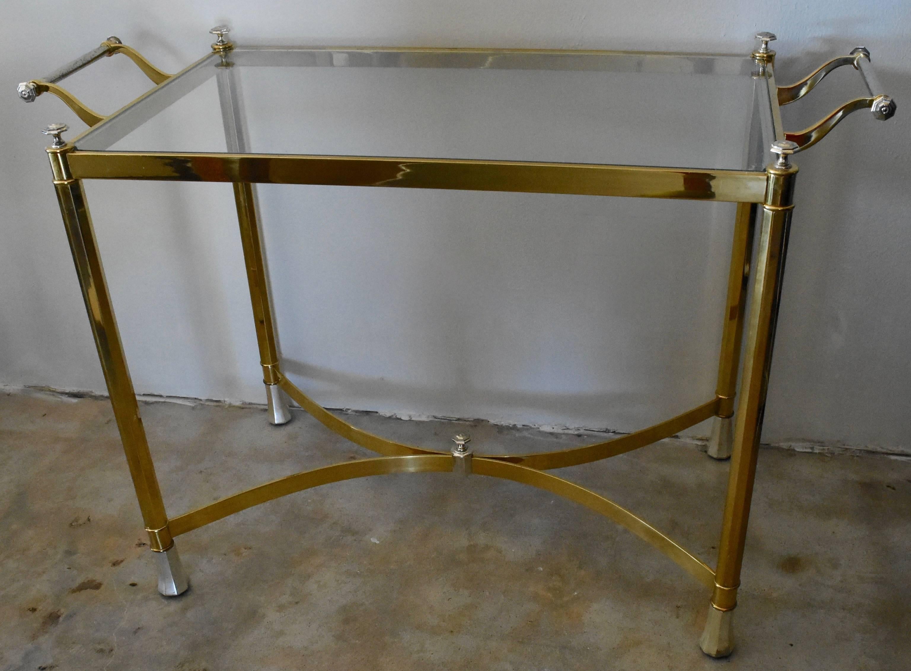 This is a adorable vintage 1970s Italian table that is great as a side table or fixed bar cart. It's brass and silver plated with a removable glass center top.
