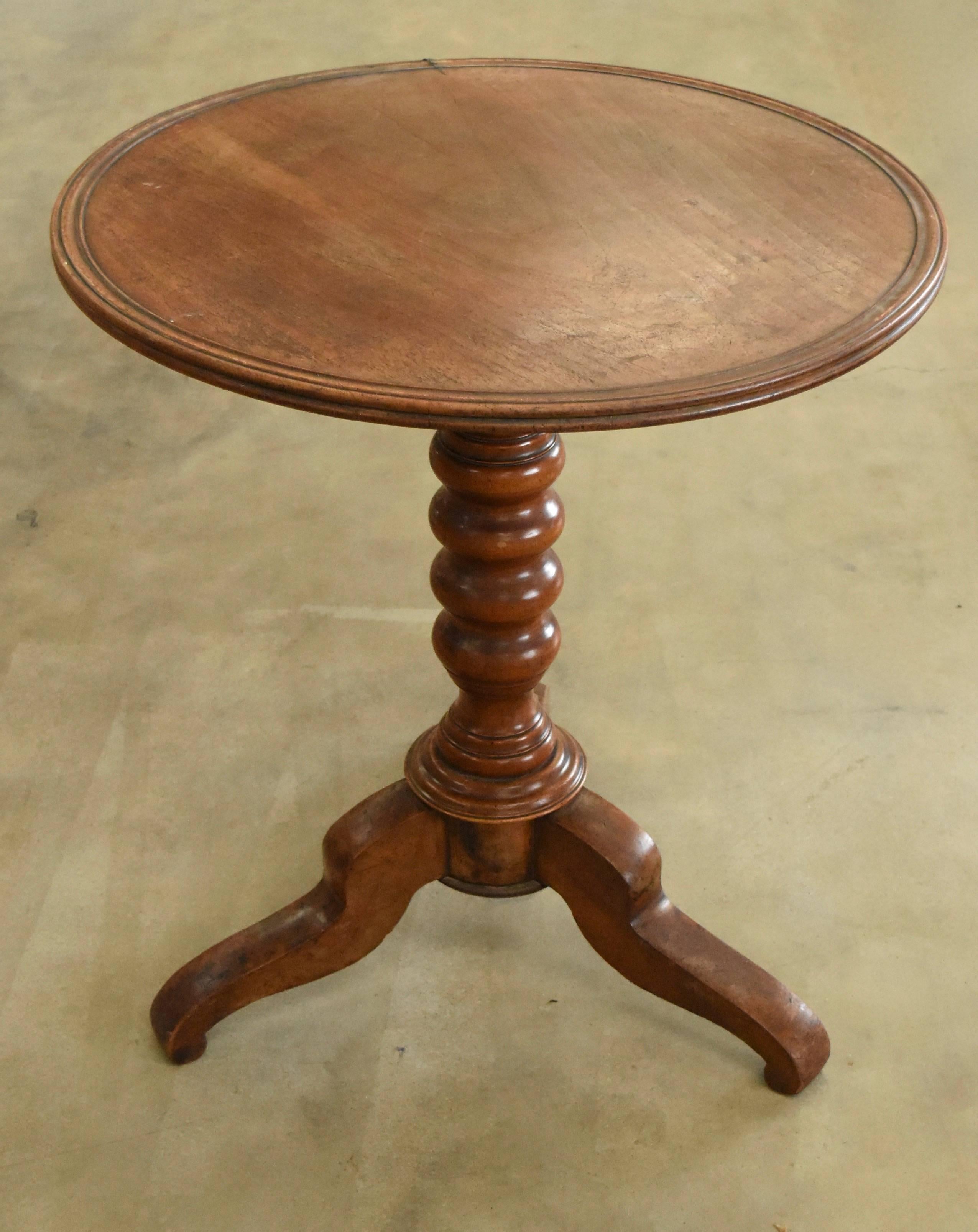 Handsome French round gueridon table that tilts so you can tuck it up against a wall. It does have a very slight slope when the top is fixed but doesn't hamper it at all.