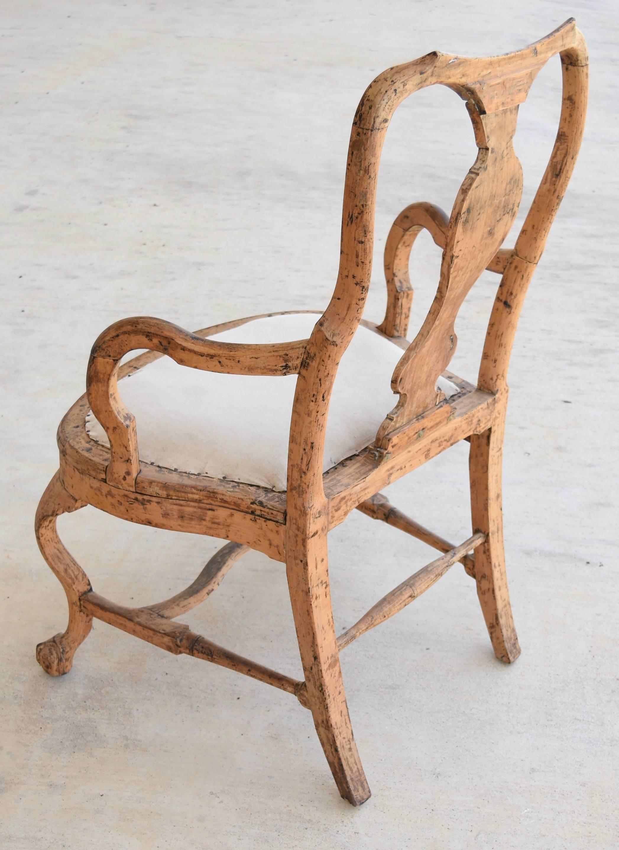 This is a large-scale, beautifully made, pegged and carved wood chair from Sweden that has it's original finish. Any angle you place it is sculpturally gorgeous. It has ball and claw front feet, sweeping curved arm, bottom stretcher and features a