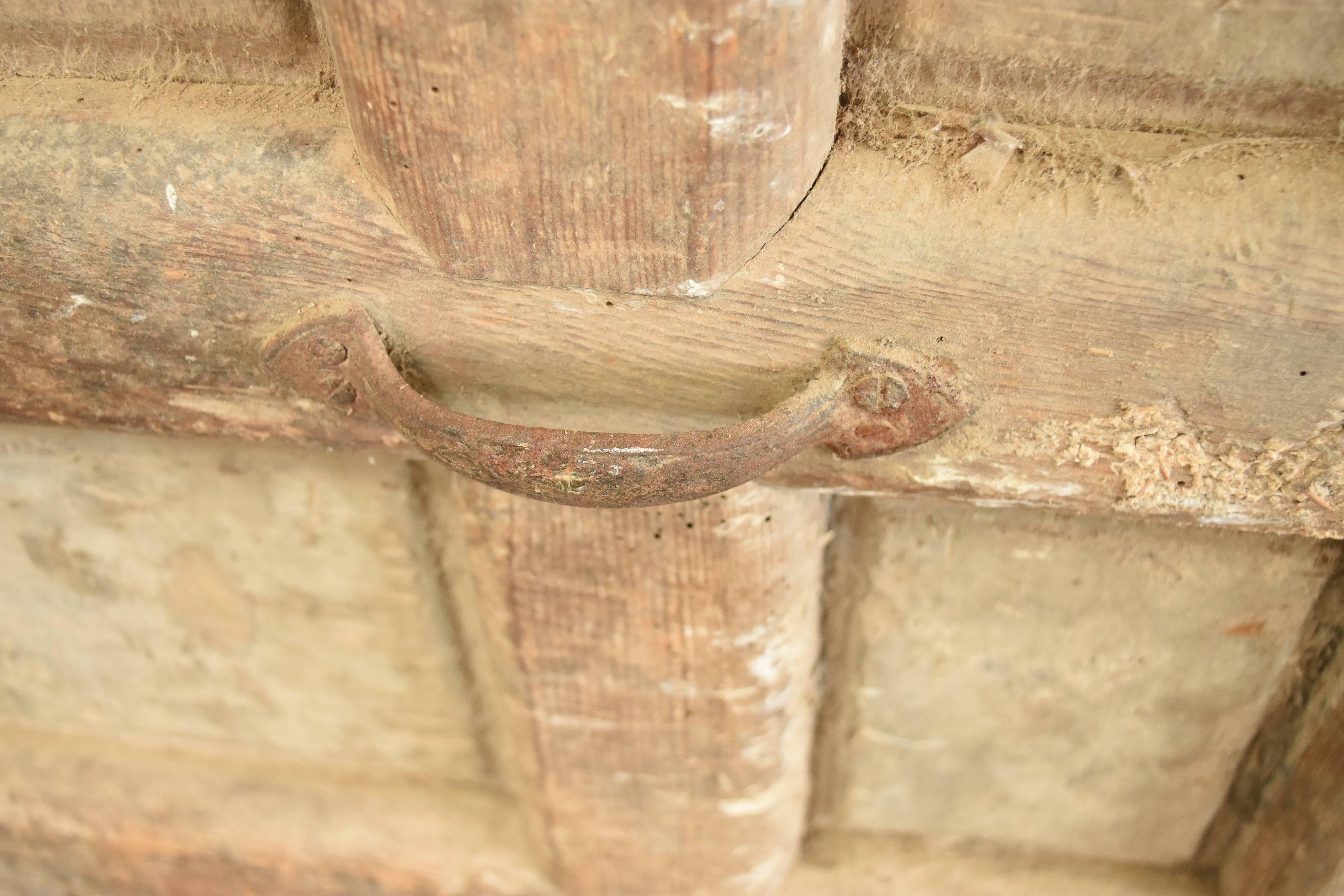 This is a well made chestnut wood door from the Catalan region of Spain with it's original hardware. It is structurally sound but rustic original condition and still has worn reddish stain from old paint in parts.